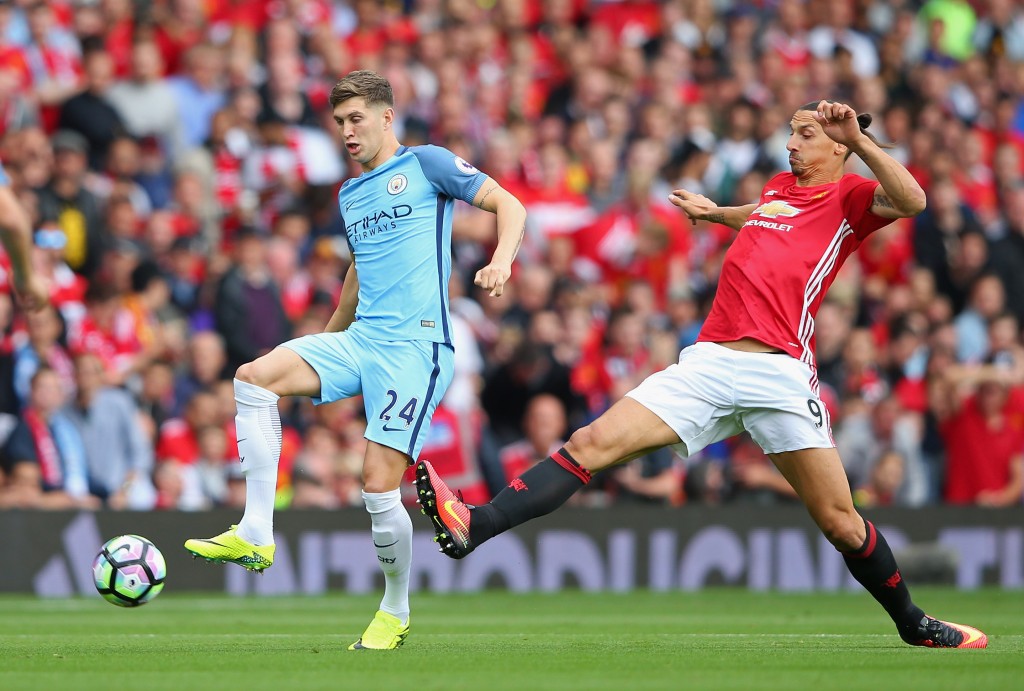 MANCHESTER, ENGLAND - SEPTEMBER 10: Zlatan Ibrahimovic of Manchester United is tackled by John Stones of Manchester City during the Premier League match between Manchester United and Manchester City at Old Trafford on September 10, 2016 in Manchester, England. (Photo by Alex Livesey/Getty Images)