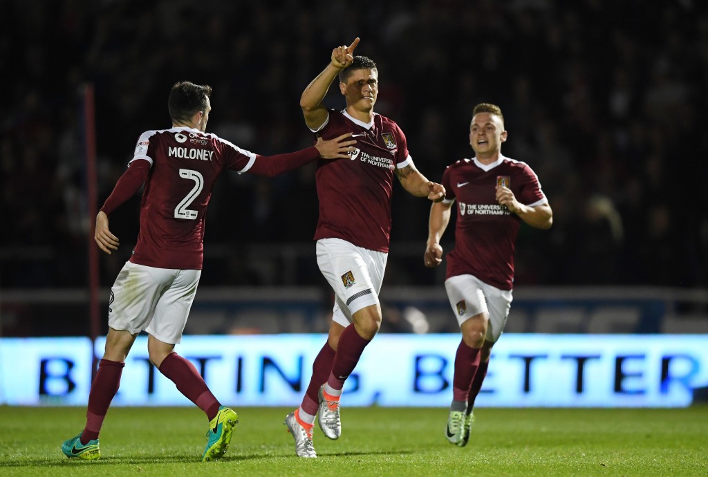 NORTHAMPTON, ENGLAND - SEPTEMBER 21: Alex Revell of Northampton Town celebrates scoring his sides first goal with team mates during the EFL Cup Third Round match between Northampton Town and Manchester United at Sixfields on September 21, 2016 in Northampton, England. (Photo by Shaun Botterill/Getty Images)