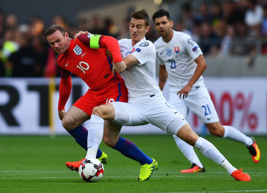 TRNAVA, SLOVAKIA - SEPTEMBER 04: Wayne Rooney of England battles with Jan Gregus of Slovakia during the 2018 FIFA World Cup Group F qualifying match between Slovakia and England at City Arena on September 4, 2016 in Trnava, Slovakia. (Photo by Dan Mullan/Getty Images)