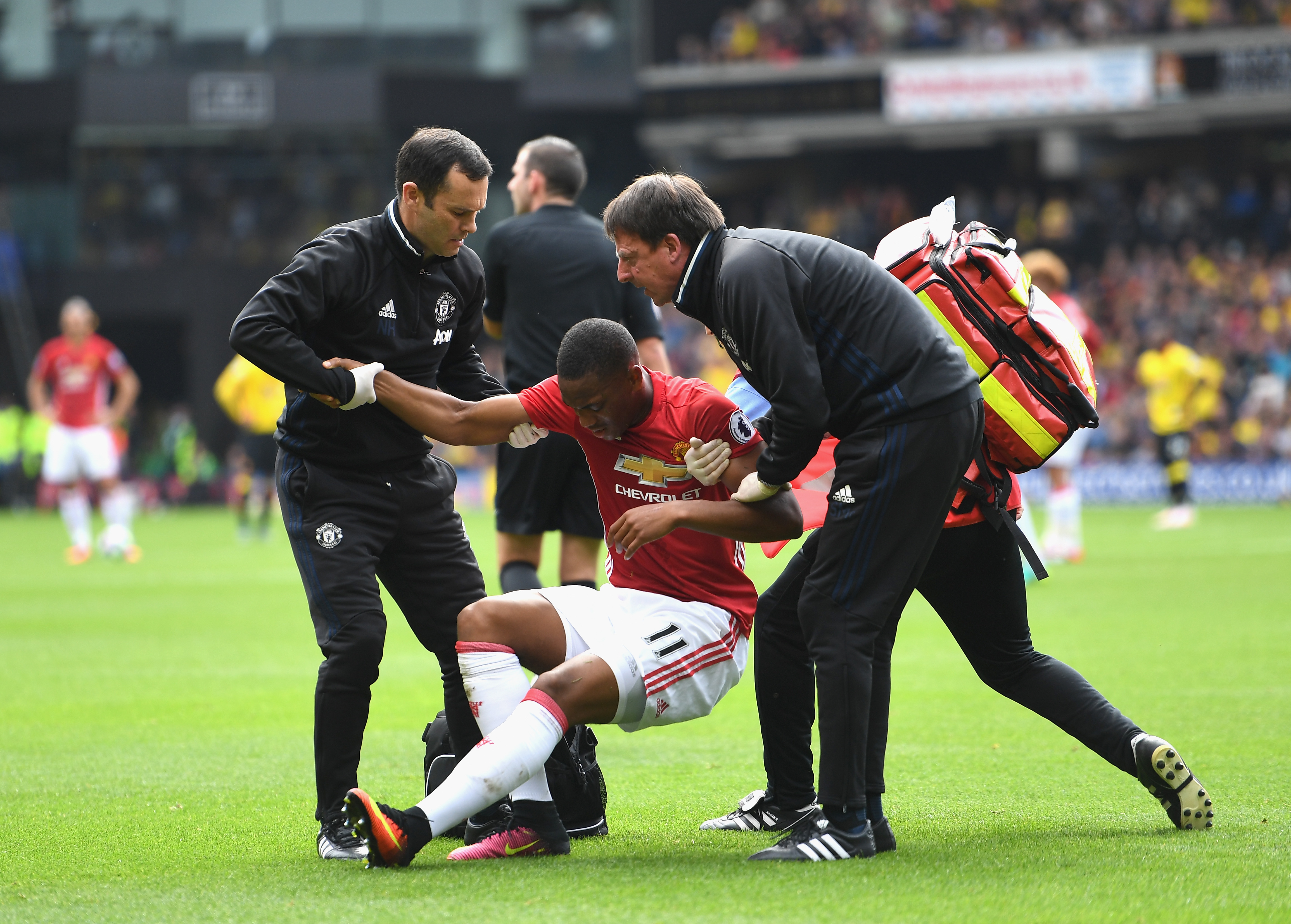 WATFORD, ENGLAND - SEPTEMBER 18: The Manchester United medical staff help Anthony Martial of Manchester United up after being injured during the Premier League match between Watford and Manchester United at Vicarage Road on September 18, 2016 in Watford, England. (Photo by Laurence Griffiths/Getty Images)
