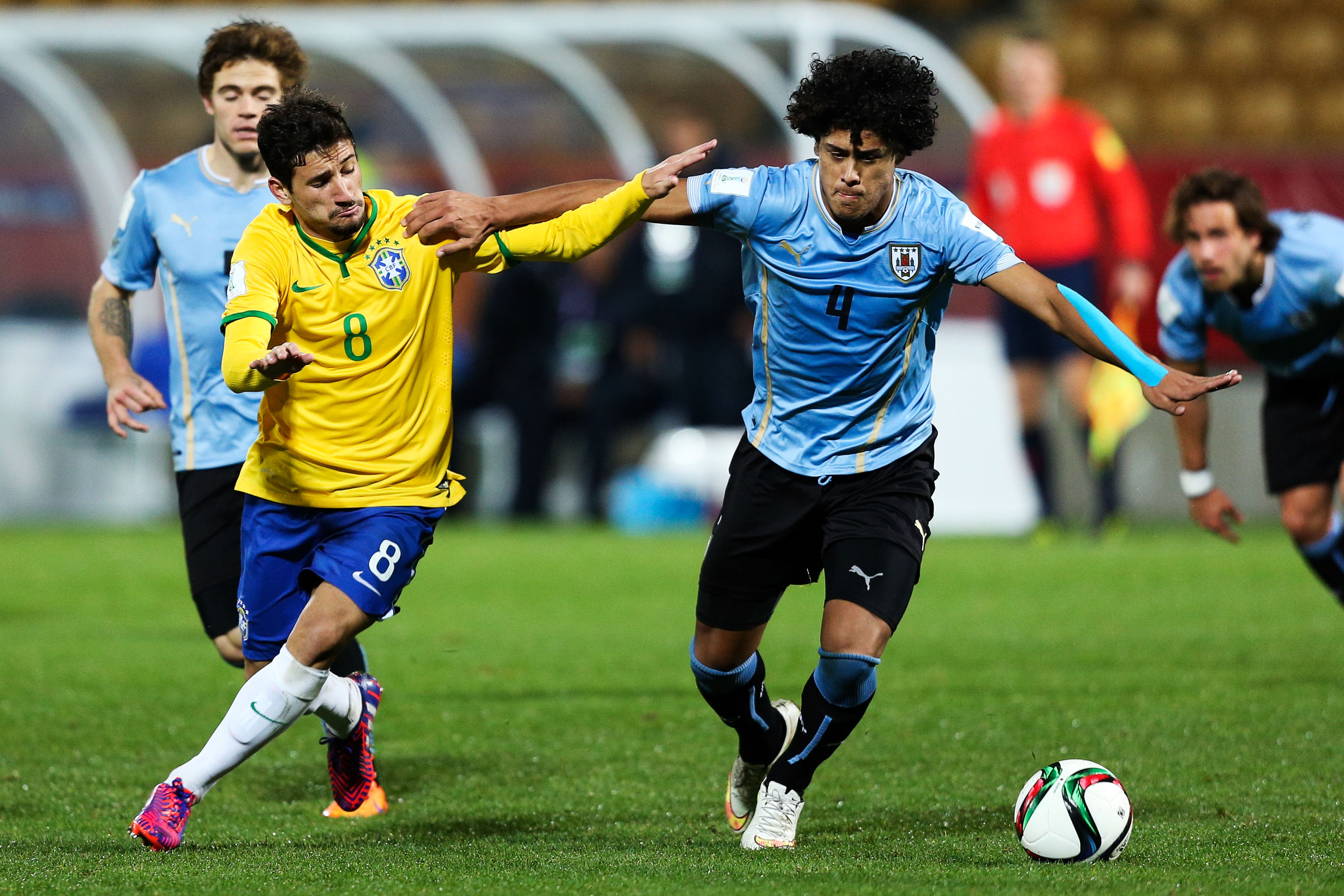 NEW PLYMOUTH, NEW ZEALAND - JUNE 11:  Boschilia of Brazil and Mauricio Lemos of Uruguay compete for the ball during the FIFA U-20 World Cup New Zealand 2015 Round of 16 match between Brazil and Uruguay at Stadium Taranaki on June 11, 2015 in New Plymouth, New Zealand.  (Photo by Hagen Hopkins/Getty Images)