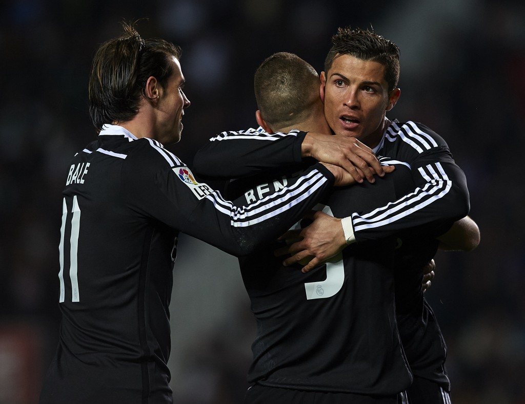 ELCHE, SPAIN - FEBRUARY 22: Karim Benzema of Real Madrid celebrates after scoring with his teammates Cristiano Ronaldo (R) and Gareth Bale during the La Liga match between Elche FC and Real Madrid at Estadio Manuel Martinez Valero on February 22, 2015 in Elche, Spain. (Photo by Manuel Queimadelos Alonso/Getty Images)