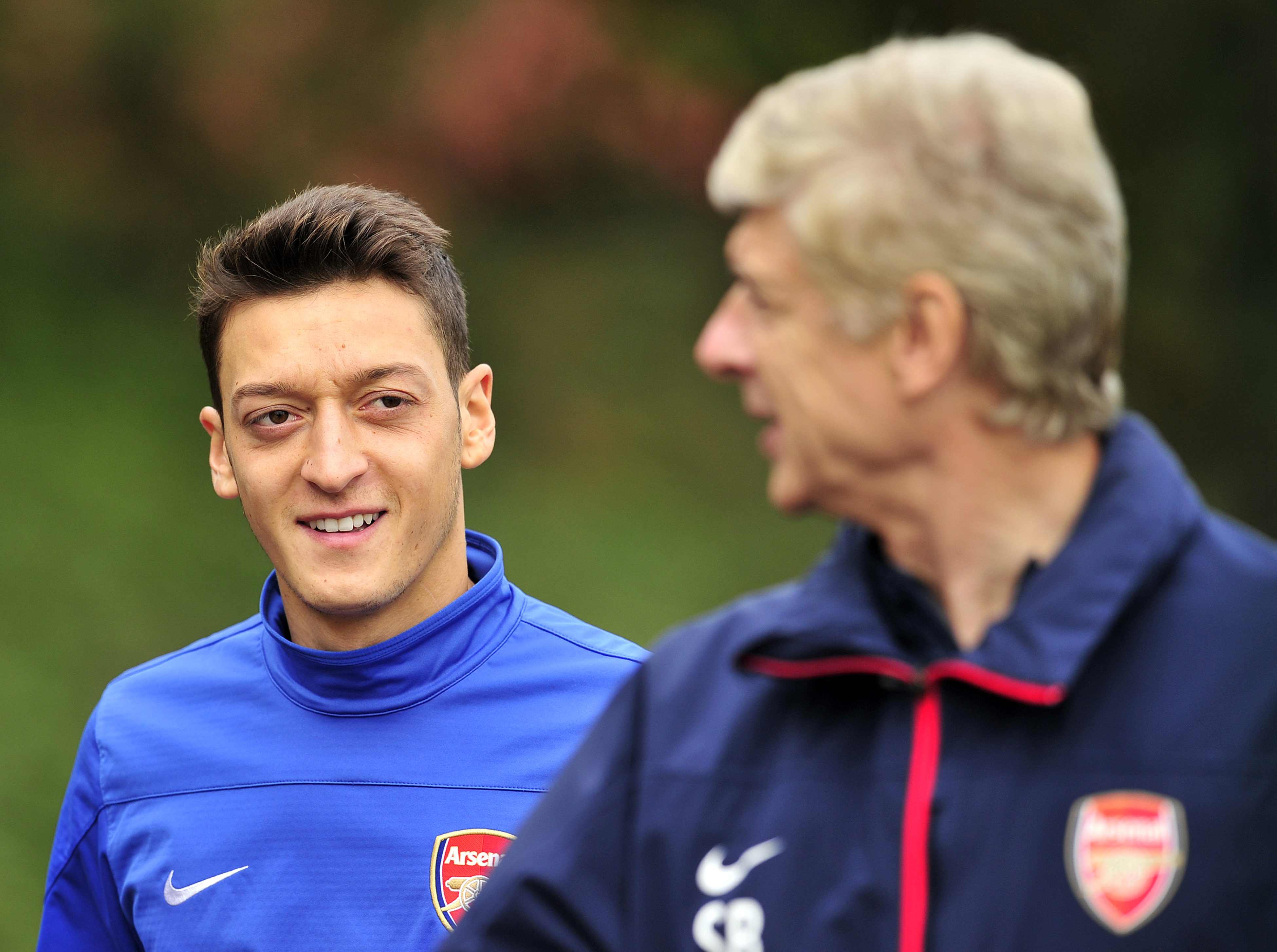 Mutual admiration. (Picture CoArsenal's German midfielder Mesut Ozil (L) and French manager Arsene Wenger (R) speak during a team training session at Arsenal's London Colney training ground in north London. (Photo by Glyn Kirk/AFP/Getty Images)