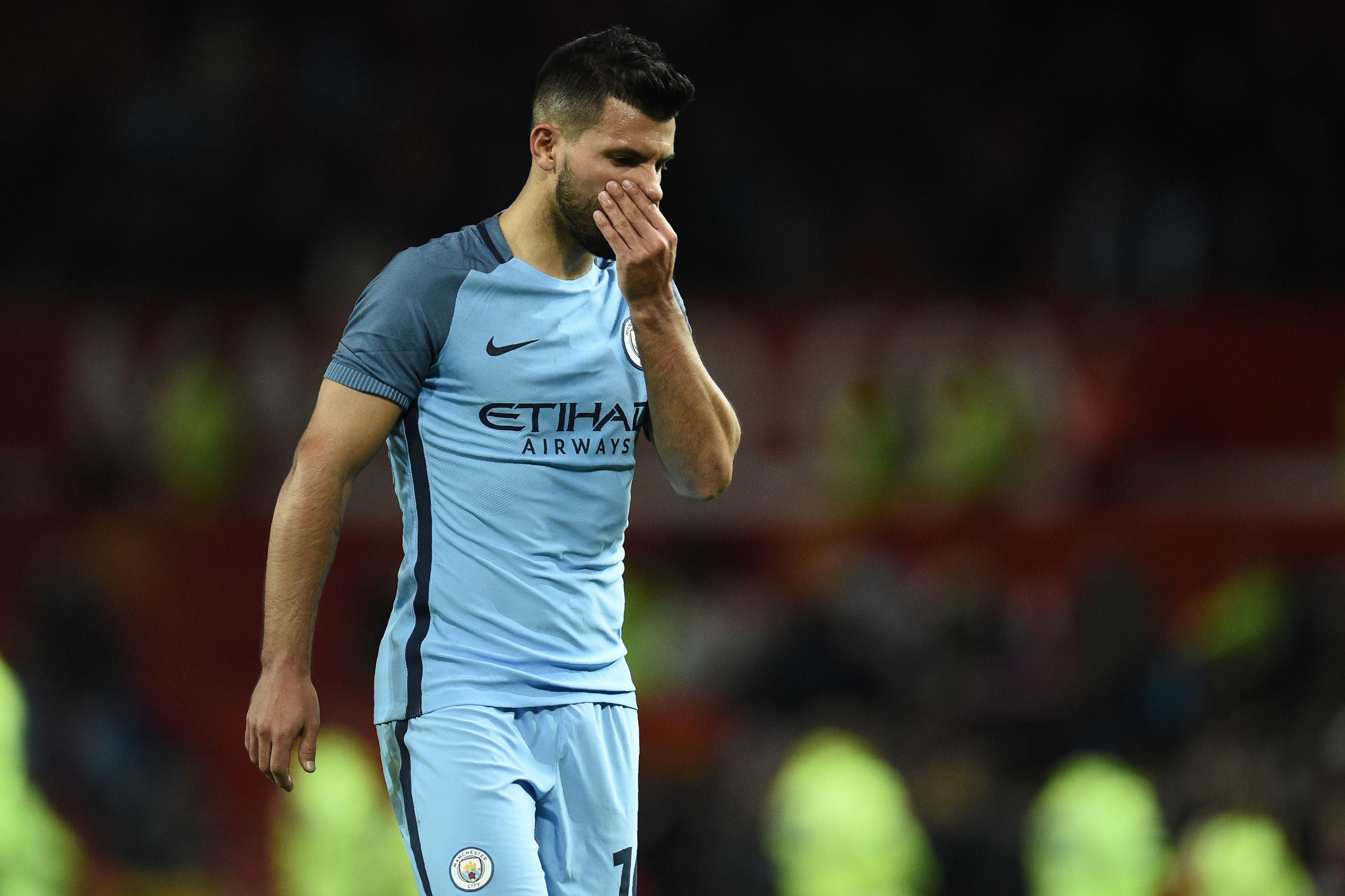 Manchester City's Argentinian striker Sergio Aguero leaves the pitch after the EFL (English Football League) Cup fourth round match between Manchester United and Manchester City at Old Trafford in Manchester, north west England on October 26, 2016.
Manchester United won the game 1-0. / AFP / Oli SCARFF / RESTRICTED TO EDITORIAL USE. No use with unauthorized audio, video, data, fixture lists, club/league logos or 'live' services. Online in-match use limited to 75 images, no video emulation. No use in betting, games or single club/league/player publications. / (Photo credit should read OLI SCARFF/AFP/Getty Images)