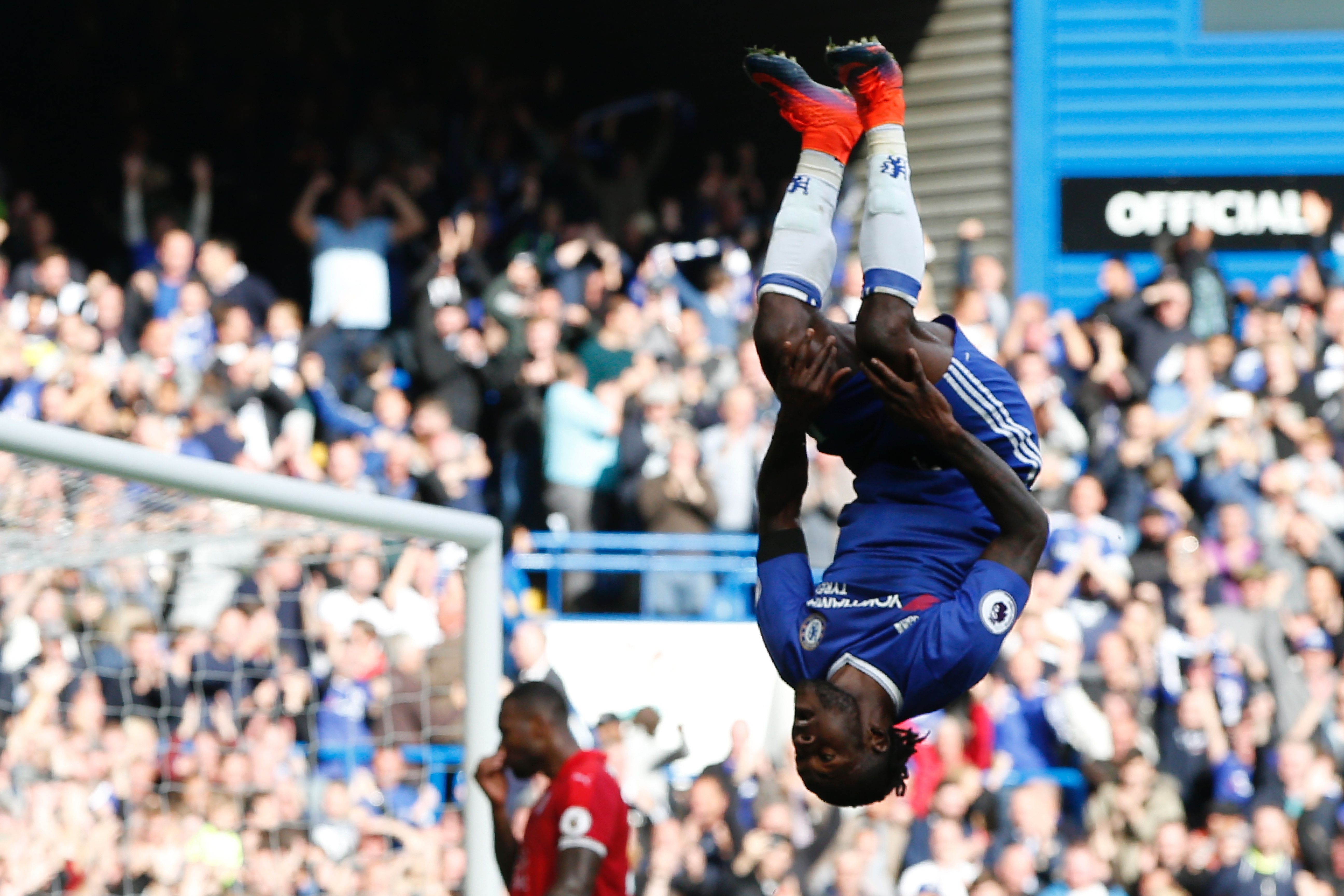 Chelsea's Nigerian midfielder Victor Moses (R) celebrates after scoring their third goal during the English Premier League football match between Chelsea and Leicester City at Stamford Bridge in London on October 15, 2016.
Chelsea won the game 3-0. (Photo by Adrian Dennis/AFP/Getty Images)
