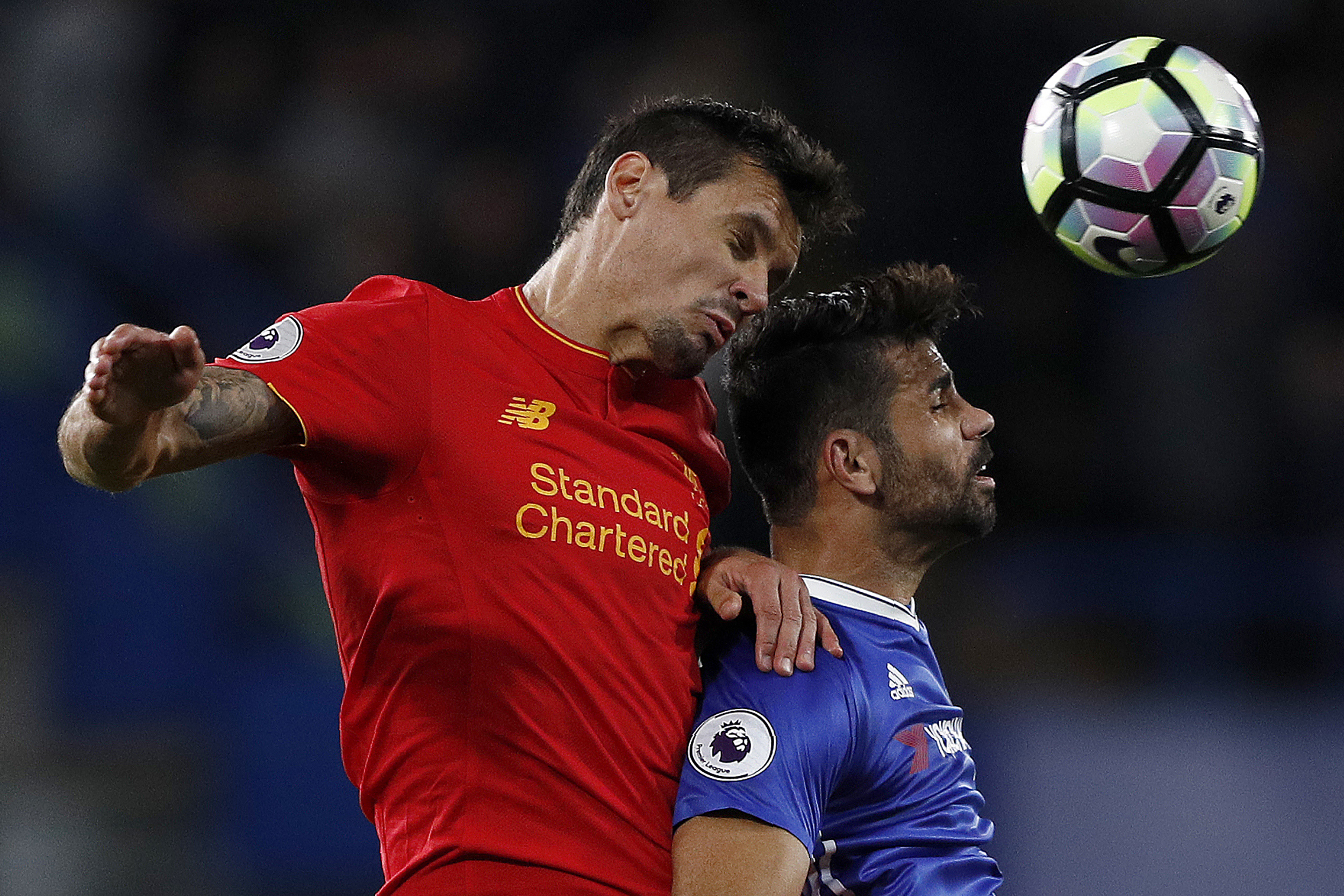 Liverpool's Croatian defender Dejan Lovren (L) and Chelsea's Brazilian-born Spanish striker Diego Costa vie for the ball during the English Premier League football match between Chelsea and Liverpool at Stamford Bridge in London on September 16, 2016. / AFP / Adrian DENNIS / RESTRICTED TO EDITORIAL USE. No use with unauthorized audio, video, data, fixture lists, club/league logos or 'live' services. Online in-match use limited to 75 images, no video emulation. No use in betting, games or single club/league/player publications. / (Photo credit should read ADRIAN DENNIS/AFP/Getty Images)
