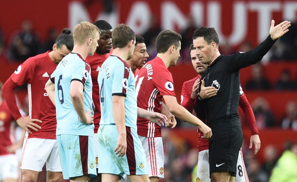 Referee Mark Clattenburg (R) gestures to Manchester United's Spanish midfielder Ander Herrera (2R) to leave the field after being sent off during the English Premier League football match between Manchester United and Burnley at Old Trafford in Manchester, north west England, on October 29, 2016. (Photo by Oli Scarff/AFP/Getty Images)