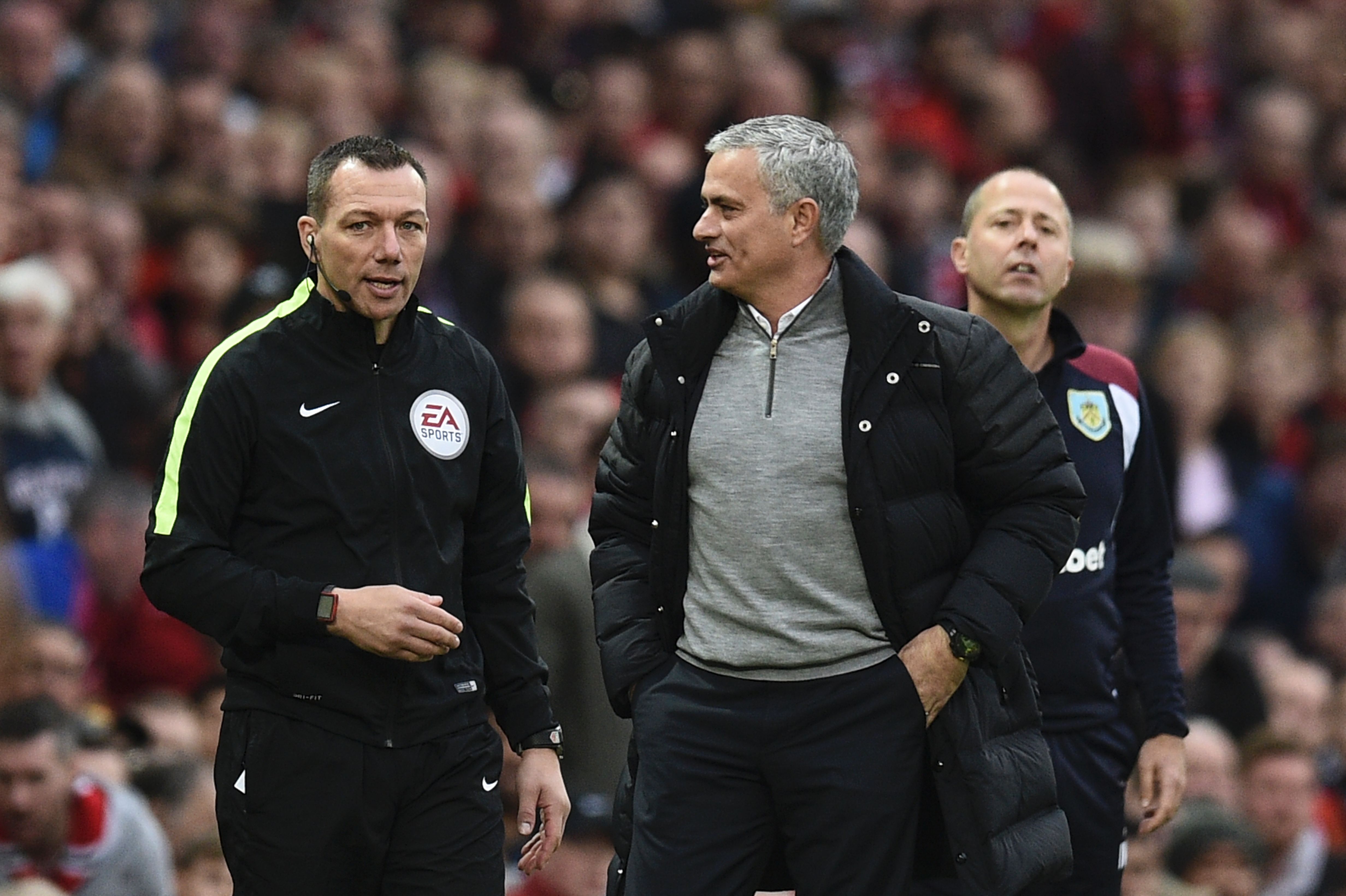 Manchester United's Portuguese manager Jose Mourinho (R) talks with fourth official Kevin Friend (L) on the touchline during the English Premier League football match between Manchester United and Burnley at Old Trafford in Manchester, north west England, on October 29, 2016. (Photo by Oli Scarff/AFP/Getty Images)