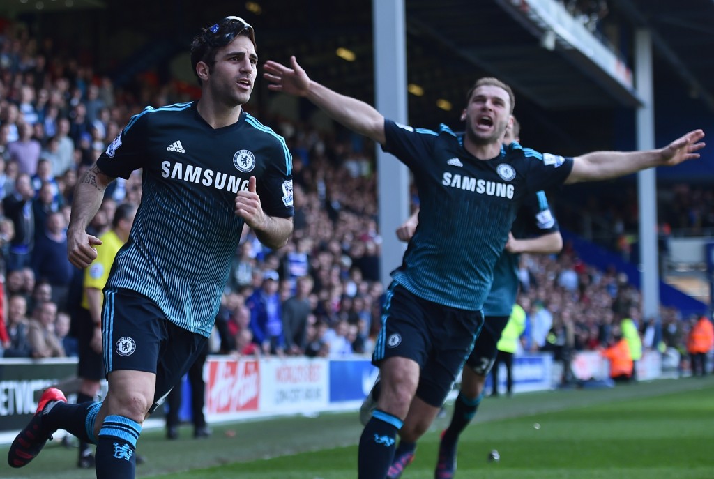 Chelsea's Spanish midfielder Cesc Fabregas (L) celebrates with Chelsea's Serbian defender Branislav Ivanovic (R) after scoring their goal during the English Premier League football match between Queens Park Rangers and Chelsea at Loftus Road Stadium in London on April 12, 2015. Chelsea won the game 1-0. AFP PHOTO / BEN STANSALL RESTRICTED TO EDITORIAL USE. NO USE WITH UNAUTHORIZED AUDIO, VIDEO, DATA, FIXTURE LISTS, CLUB/LEAGUE LOGOS OR "LIVE" SERVICES. ONLINE IN-MATCH USE LIMITED TO 45 IMAGES, NO VIDEO EMULATION. NO USE IN BETTING, GAMES OR SINGLE CLUB/LEAGUE/PLAYER PUBLICATIONS. (Photo credit should read BEN STANSALL/AFP/Getty Images)