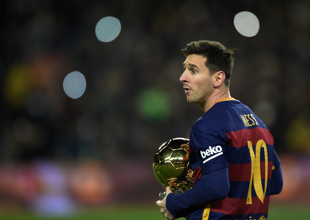 Barcelona's Argentinian forward Lionel Messi walks away after posing with his fifth Ballon d'Or trophy before the Spanish league football match FC Barcelona vs Athletic Club Bilbao at the Camp Nou stadium in Barcelona on January 17, 2016. / AFP / LLUIS GENE (Photo credit should read LLUIS GENE/AFP/Getty Images)