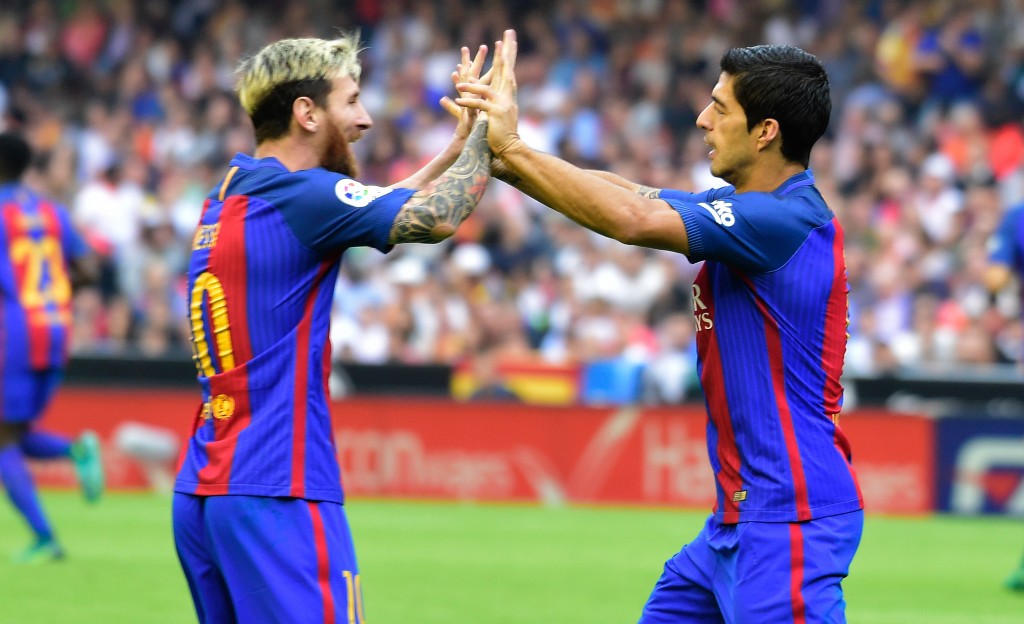 Barcelona's Uruguayan forward Luis Suarez (R) celebrates with Barcelona's Argentinian forward Lionel Messi after scoring during the Spanish league football match Valencia CF vs FC Barcelona at the Mestalla stadium in Valencia on October 22, 2016. / AFP / JOSE JORDAN (Photo credit should read JOSE JORDAN/AFP/Getty Images)