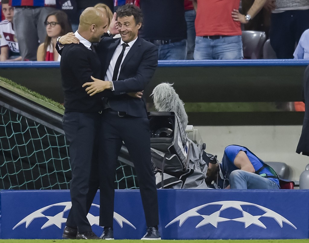Bayern Munich's Spanish head coach Pep Guardiola (L) and Barcelona's coach Luis Enrique hug after the UEFA Champions League semi-final second leg football match FC Bayern Munich vs FC Barcelona in Munich, southern Germany, on May 12, 2015. AFP PHOTO / STR (Photo credit should read -/AFP/Getty Images)