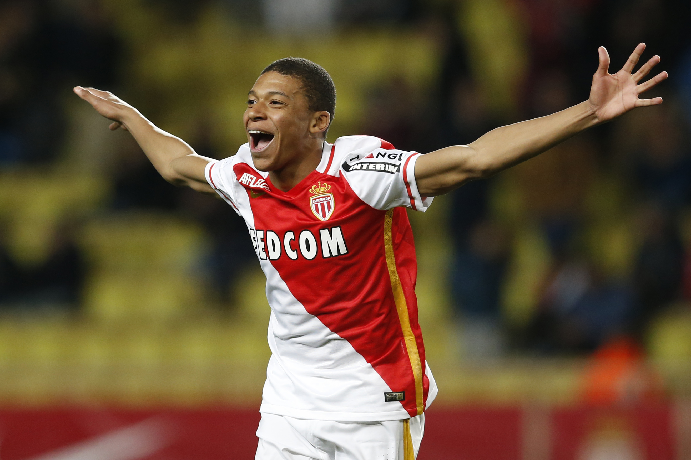 Monaco's French forward Kylian Mbappe Lottin celebrates after scoring a goal during the French L1 football match Monaco (ASM) vs Troyes (ESTAC) on February 20, 2016 at the "Louis II Stadium" in Monaco. AFP PHOTO / VALERY HACHE / AFP / VALERY HACHE (Photo credit should read VALERY HACHE/AFP/Getty Images)