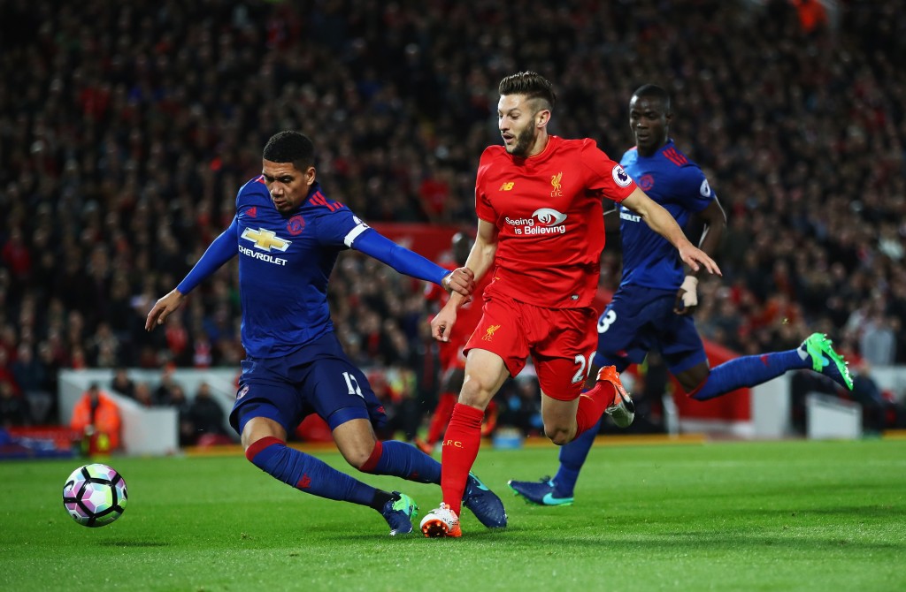 LIVERPOOL, ENGLAND - OCTOBER 17: Adam Lallana of Liverpool is challenged by Chris Smalling of Manchester United during the Premier League match between Liverpool and Manchester United at Anfield on October 17, 2016 in Liverpool, England. (Photo by Clive Brunskill/Getty Images)