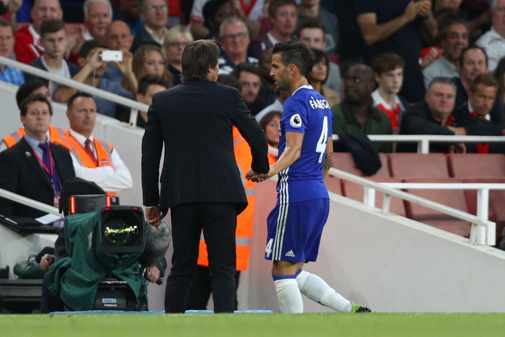 LONDON, ENGLAND - SEPTEMBER 24: Cesc Fabregas of Chelsea (R) speaks to Antonio Conte, Manager of Chelsea (L) after being subbed during the Premier League match between Arsenal and Chelsea at the Emirates Stadium on September 24, 2016 in London, England. (Photo by Paul Gilham/Getty Images)