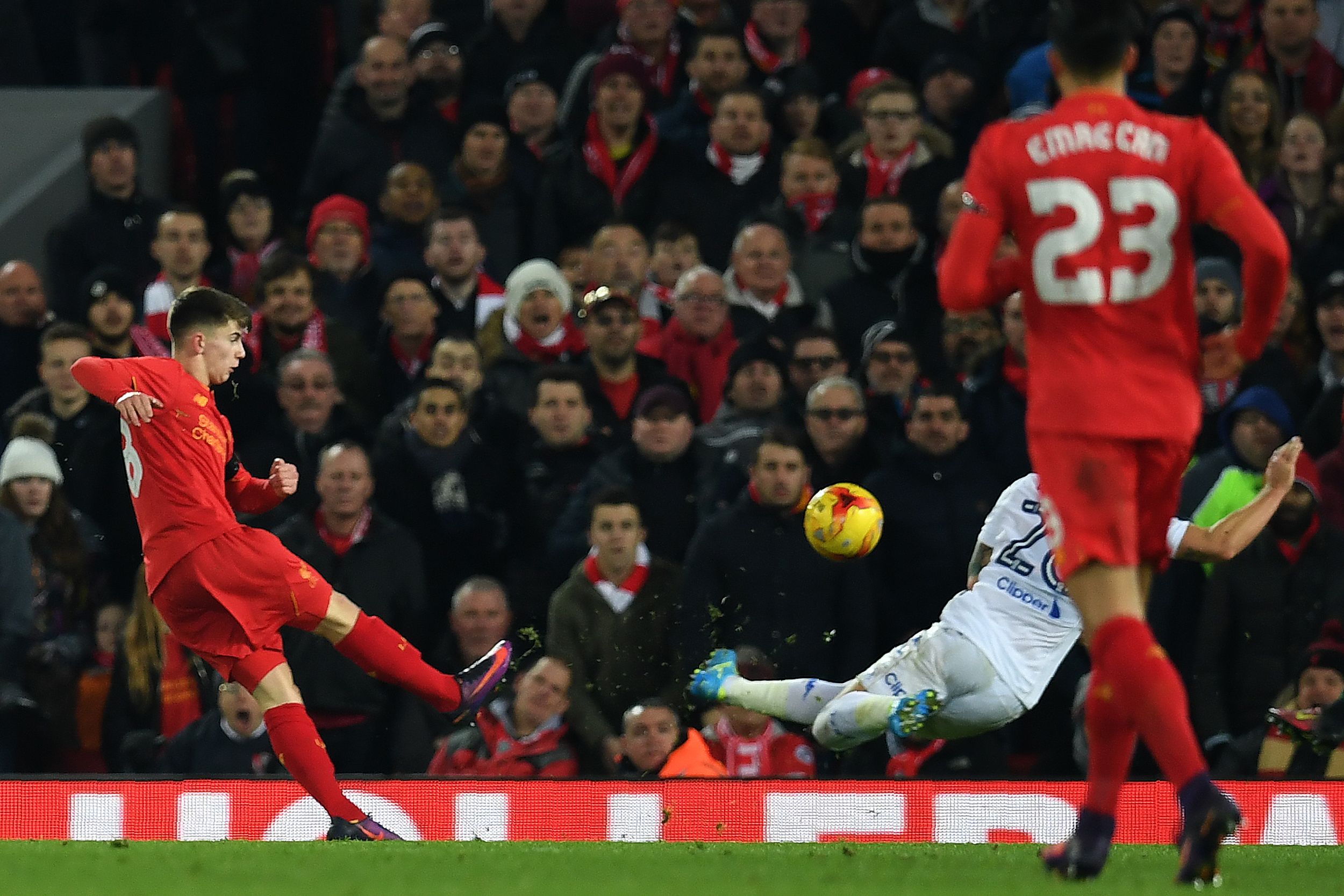 Liverpool's Welsh striker Ben Woodburn scores his team's second goal during the EFL (English Football League) Cup quarter-final football match between Liverpool and Leeds United at Anfield in Liverpool, north west England on November 29, 2016. / AFP / Paul ELLIS / RESTRICTED TO EDITORIAL USE. No use with unauthorized audio, video, data, fixture lists, club/league logos or 'live' services. Online in-match use limited to 75 images, no video emulation. No use in betting, games or single club/league/player publications. / (Photo credit should read PAUL ELLIS/AFP/Getty Images)