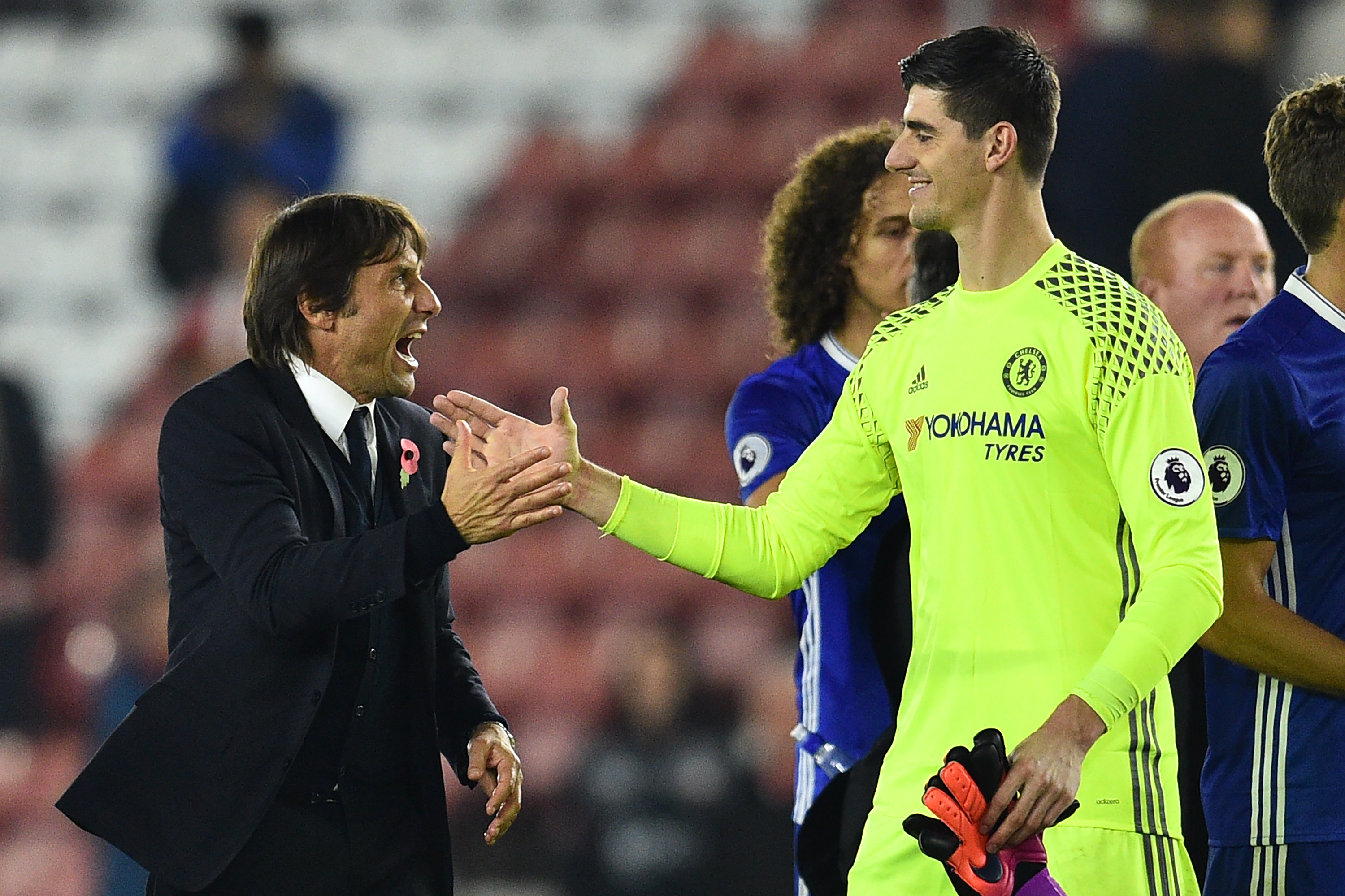 Chelsea's Italian head coach Antonio Conte (L) celebrates with Chelsea's Belgian goalkeeper Thibaut Courtois on the pitch after the English Premier League football match between Southampton and Chelsea at St Mary's Stadium in Southampton, southern England on October 30, 2016.
Chelsea won the game 2-0. / AFP / GLYN KIRK / RESTRICTED TO EDITORIAL USE. No use with unauthorized audio, video, data, fixture lists, club/league logos or 'live' services. Online in-match use limited to 75 images, no video emulation. No use in betting, games or single club/league/player publications. / (Photo credit should read GLYN KIRK/AFP/Getty Images)