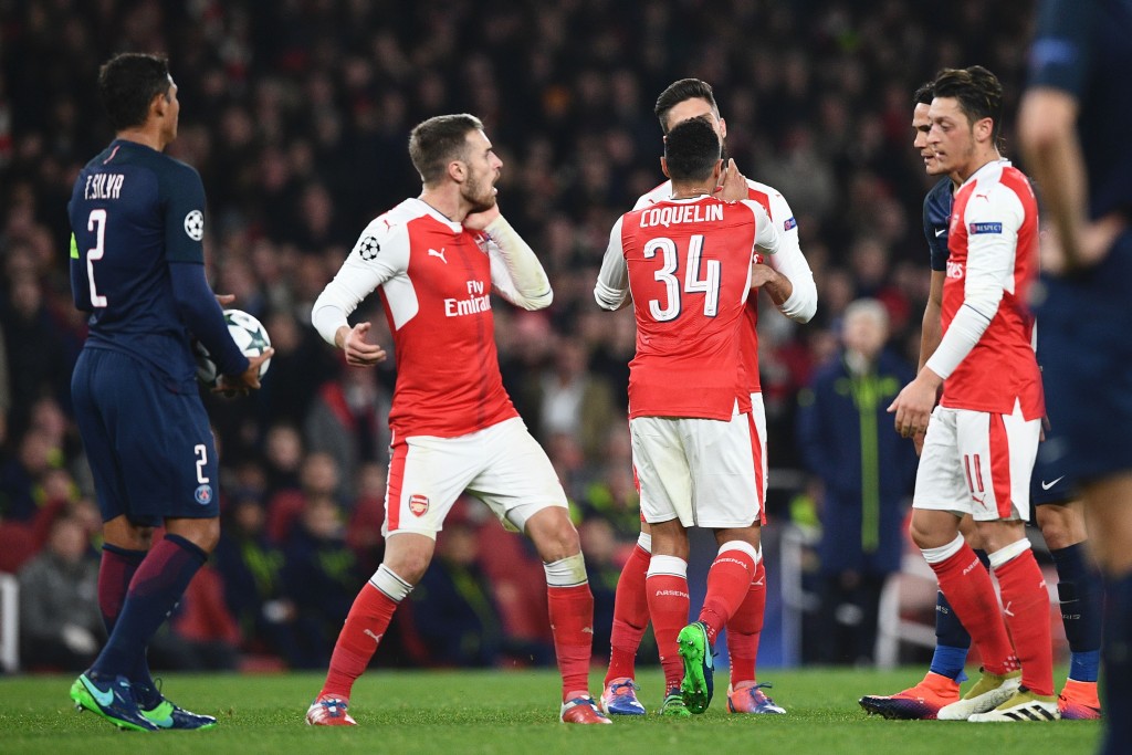 Arsenal's Welsh midfielder Aaron Ramsey (2L) puts his hand to his cheek after a scuffle with Paris Saint-Germain's Uruguayan forward Edinson Cavani (2R) after Arsenal were awarded a penalty during the UEFA Champions League group A football match between Arsenal and Paris Saint-Germain at the Emirates Stadium in London on November 23, 2016. / AFP / Justin TALLIS (Photo credit should read JUSTIN TALLIS/AFP/Getty Images)