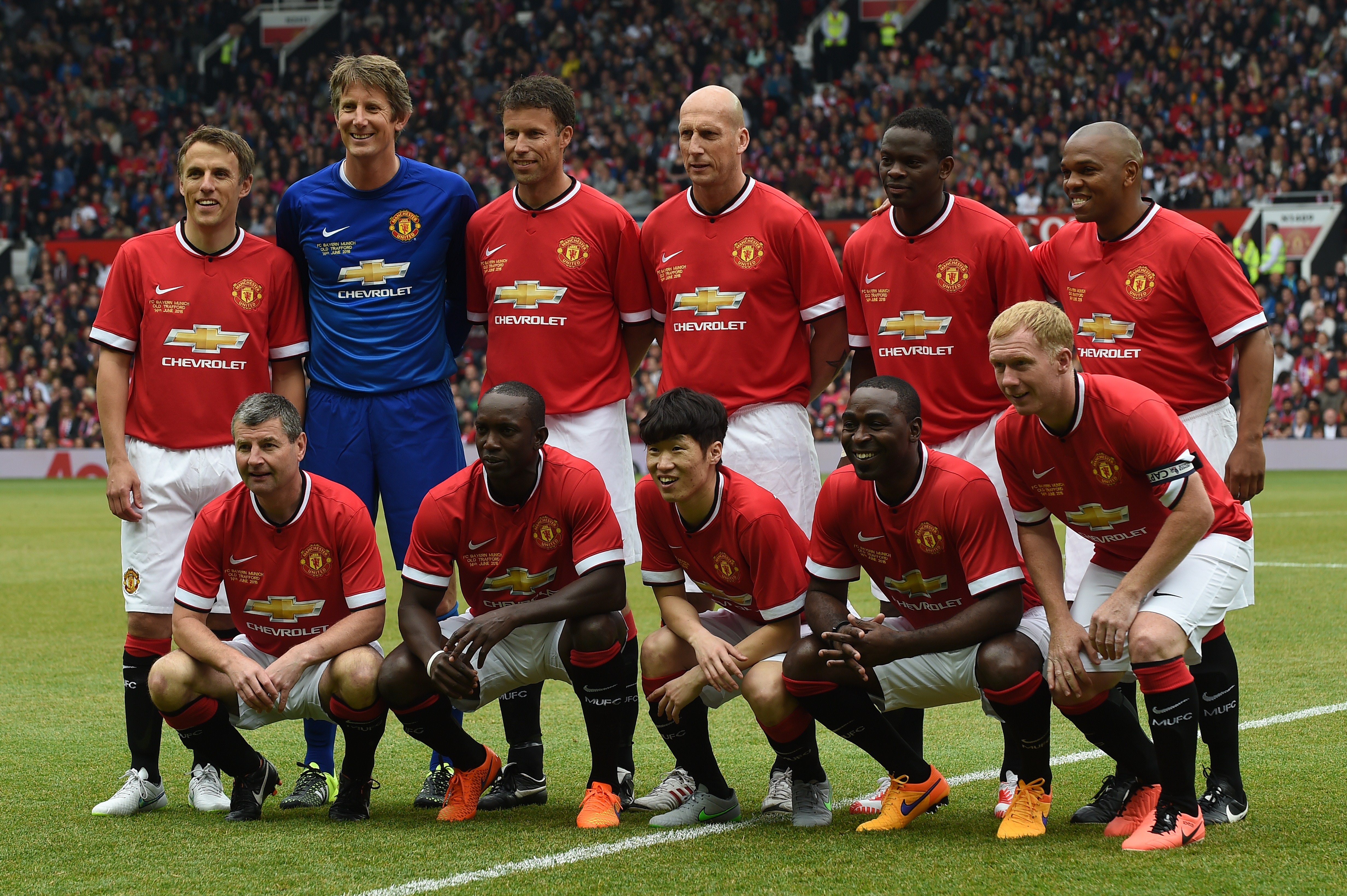 Manchester Utd legends (top L-R) Phil Neville, Edwin van der Sar, Ronny Johnsen, Jaap Stam, Louis Saha, Quinton Fortune (bottom L-R) Denis Irwin, Dwight Yorke, Park Ji-Sung, Andy Cole and Paul Scholes pose for a team photograph at the start of the friendly football match between Manchester United's Legends and Bayern Munich All Stars at Old Trafford in Manchester, northwest England, on June 14, 2015. The charity friendly football match reuniting former Manchester United stars with legends from Bayern Munich was played in aid of the Manchester United Foundation. AFP PHOTO / PAUL ELLIS (Photo credit should read PAUL ELLIS/AFP/Getty Images)