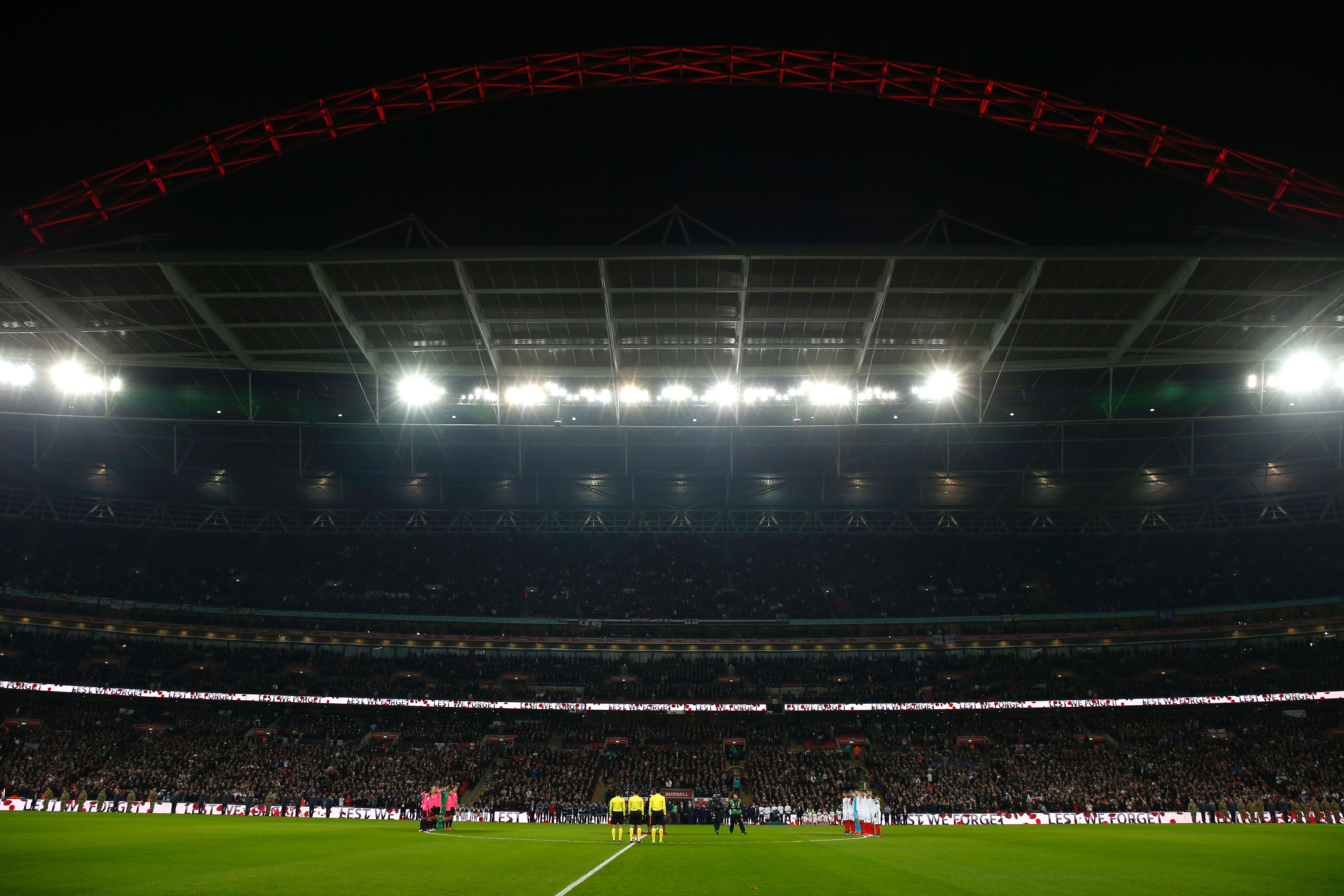 The teams of Scotland and England stand for a minutes silence to honour the war dead before a World Cup 2018 qualification match between England and Scotland at Wembley stadium in London on November 11, 2016. / AFP / Ian Kington / NOT FOR MARKETING OR ADVERTISING USE / RESTRICTED TO EDITORIAL USE
(Photo credit should read IAN KINGTON/AFP/Getty Images)