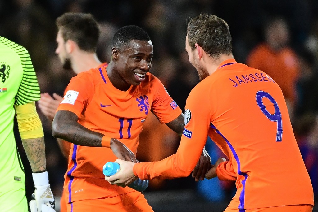 Netherlands' Quincy Promes (C) and Netherlands' Vincent Janssen (R) celebrate after their team's victory during the FIFA World Cup 2018 qualification football match between The Netherlands and Belarus at Feyenoord Stadium in Rotterdam on October 7, 2016. / AFP / EMMANUEL DUNAND (Photo credit should read EMMANUEL DUNAND/AFP/Getty Images)