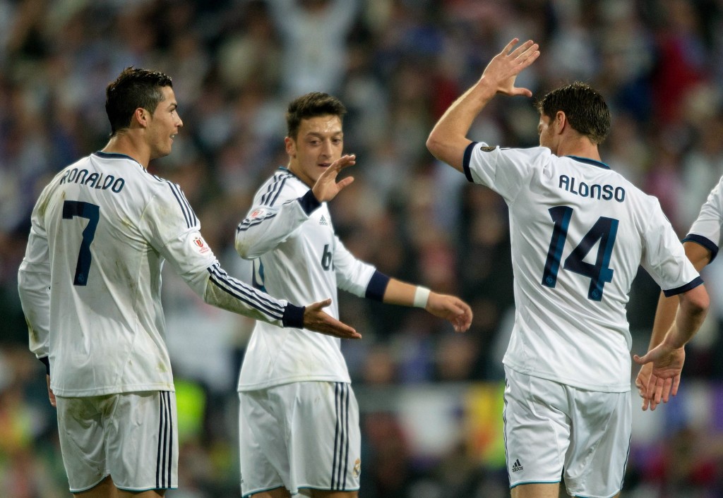 MADRID, SPAIN - MAY 17: Cristiano Ronaldo (L) of Real Madrid CF celebrates with teammates Mesut Ozil (C) and Xabi Alonso (R) after scoring the opening goal during the Copa del Rey Final match between Real Madrid CF and Club Atletico de Madrid at Estadio Santiago Bernabeu on May 17, 2013 in Madrid, Spain. (Photo by Gonzalo Arroyo/Getty Images)