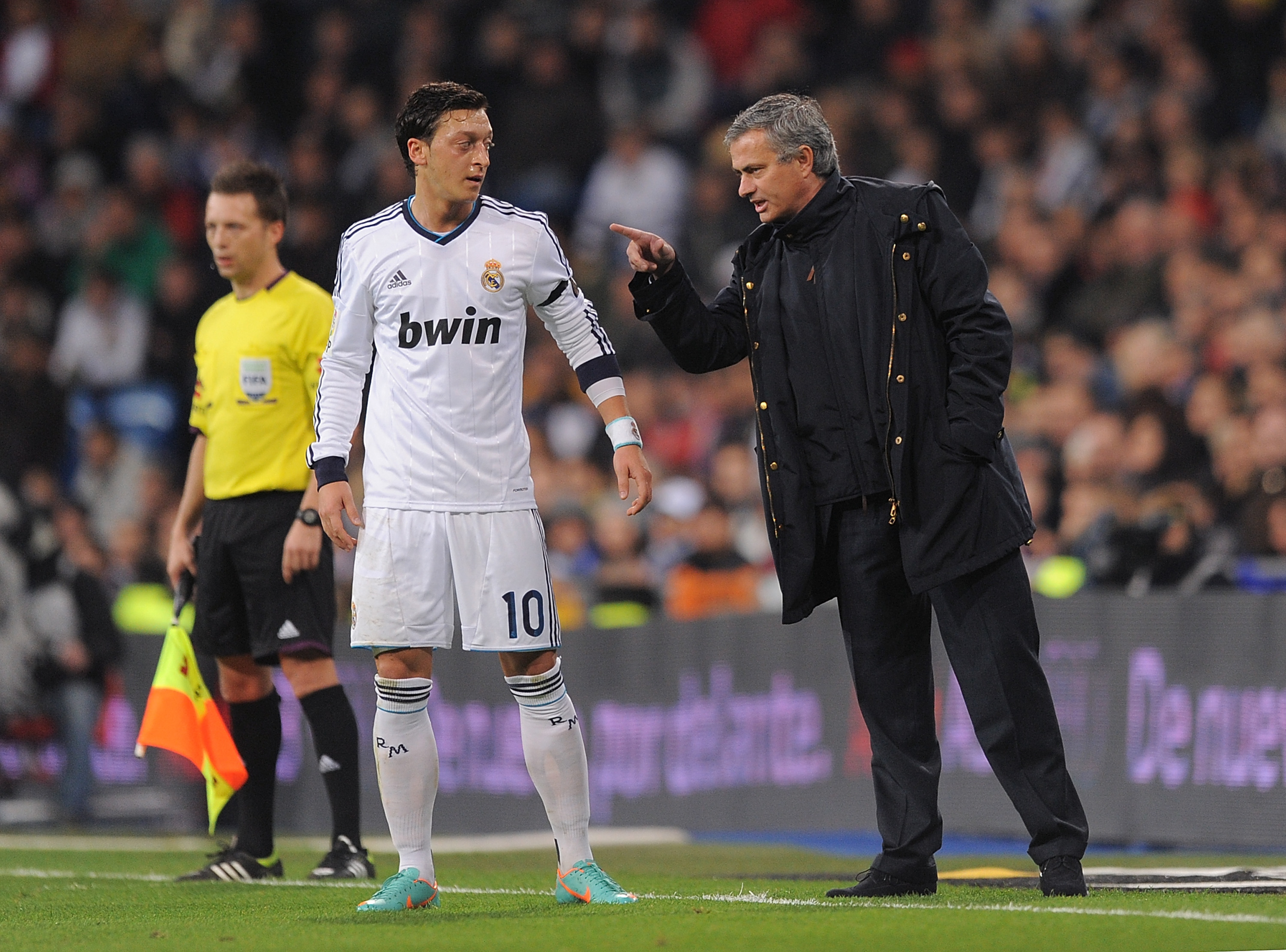 MADRID, SPAIN - DECEMBER 16:  Real Madrid CF head coach Jose Mourinho talks with Mesut Ozil of Real Madrid during the La Liga match between Real Madrid CF and RCD Espanyol at estadio Santiago Bernabeu on December 16, 2012 in Madrid, Spain.  (Photo by Denis Doyle/Getty Images)