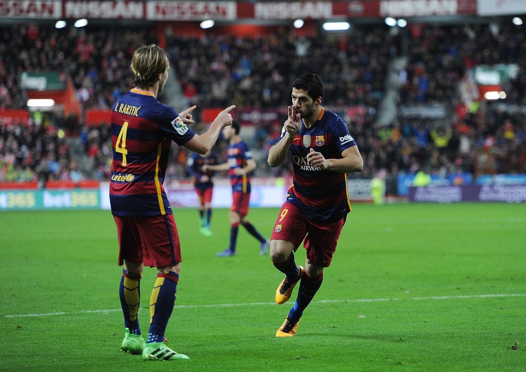 GIJON, SPAIN - FEBRUARY 17: Luis Suarez of FC Barcelona celebrates with Ivan Rakitic after scoring his team's 3rd goal during the La Liga match between Sporting Gijon and FC Barcelona at Estadio El Molinon on February 17, 2016 in Gijon, Spain. (Photo by Denis Doyle/Getty Images)