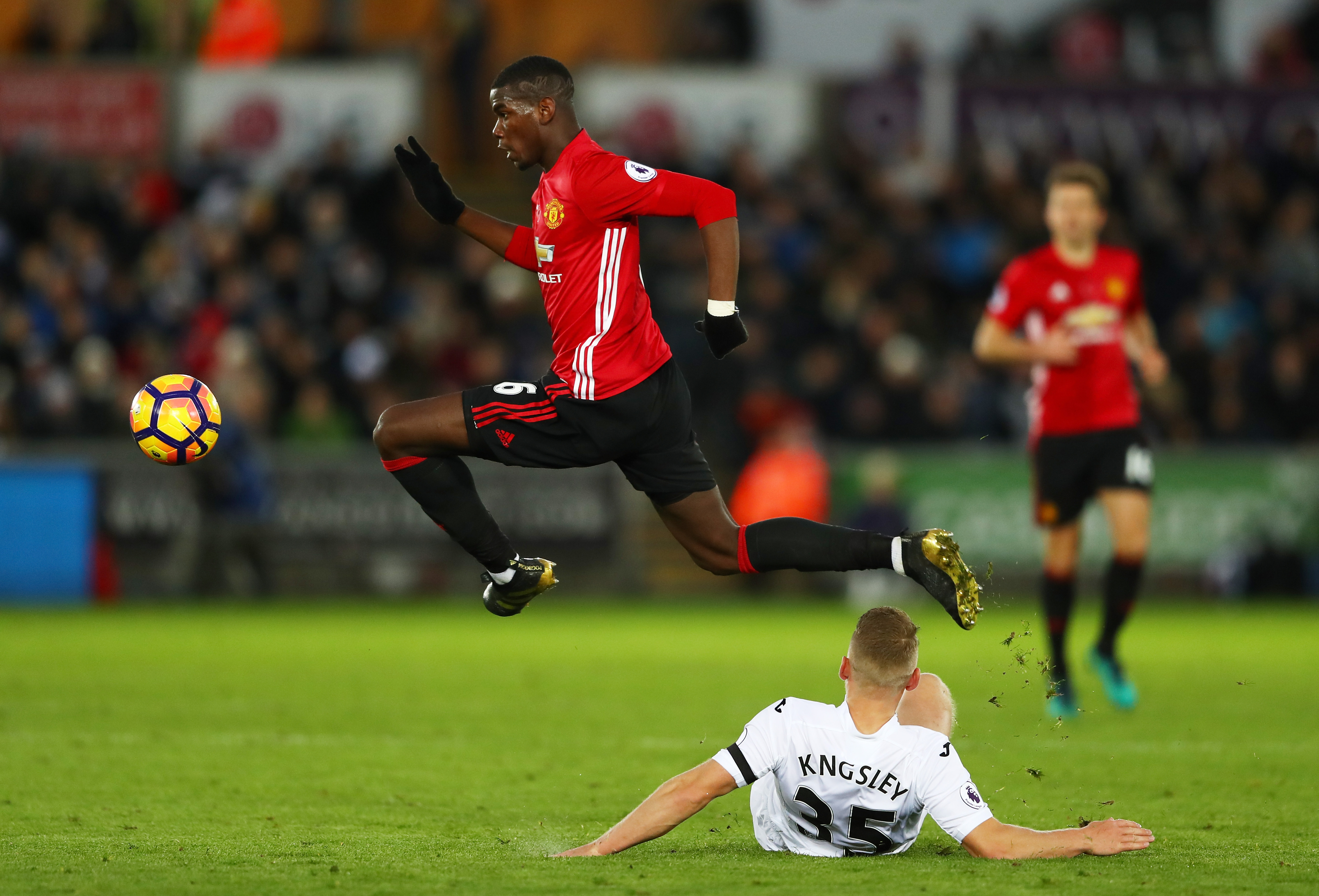SWANSEA, WALES - NOVEMBER 06: Stephen Kingsley of Swansea City attempts to tackle Paul Pogba of Manchester United during the Premier League match between Swansea City and Manchester United at Liberty Stadium on November 6, 2016 in Swansea, Wales. (Photo by Michael Steele/Getty Images)