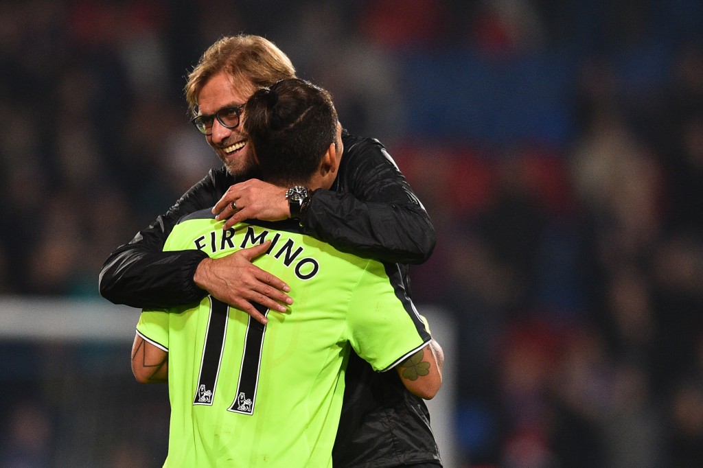 Liverpool's German manager Jurgen Klopp celebrates on the pitch with Liverpool's Brazilian midfielder Roberto Firmino after the English Premier League football match between Crystal Palace and Liverpool at Selhurst Park in south London on October 29, 2016. Liverpool won the game 4-2. / AFP / Glyn KIRK / RESTRICTED TO EDITORIAL USE. No use with unauthorized audio, video, data, fixture lists, club/league logos or 'live' services. Online in-match use limited to 75 images, no video emulation. No use in betting, games or single club/league/player publications. / (Photo credit should read GLYN KIRK/AFP/Getty Images)