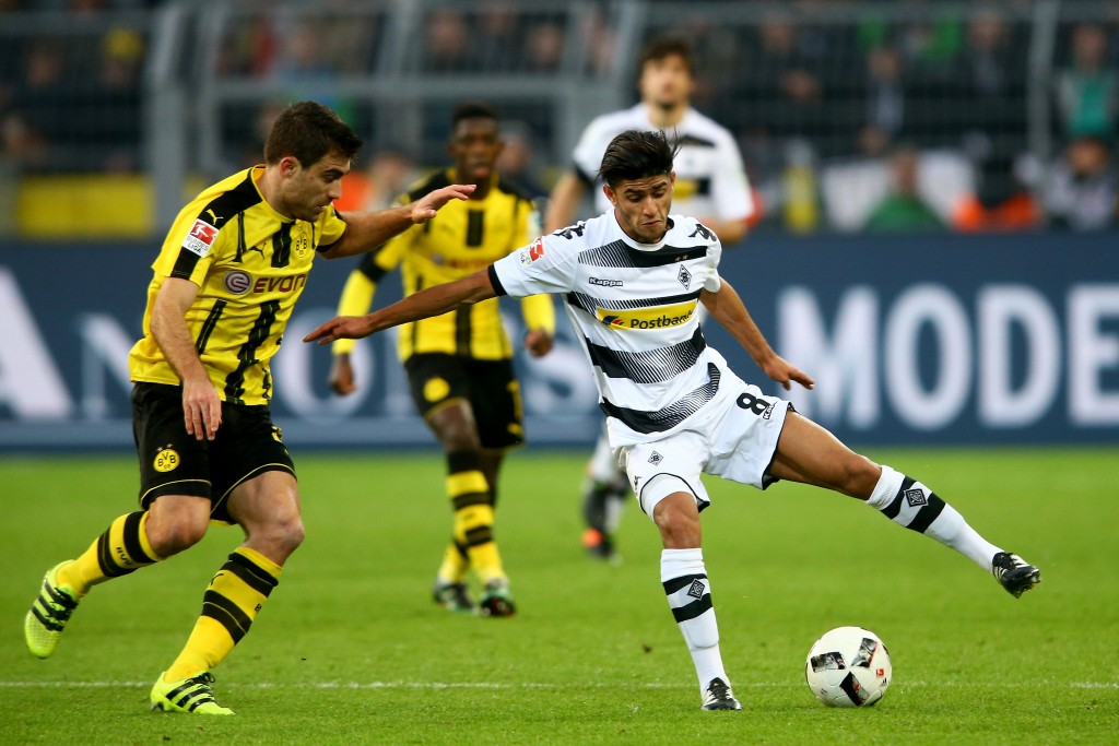 DORTMUND, GERMANY - DECEMBER 03: (L-R) Sokratis of Dortmund challenges Mahmoud Dahoud of Moenchengladbach during the Bundesliga match between Borussia Dortmund and Borussia Moenchengladbach at Signal Iduna Park on December 3, 2016 in Dortmund, Germany. (Photo by Christof Koepsel/Bongarts/Getty Images)