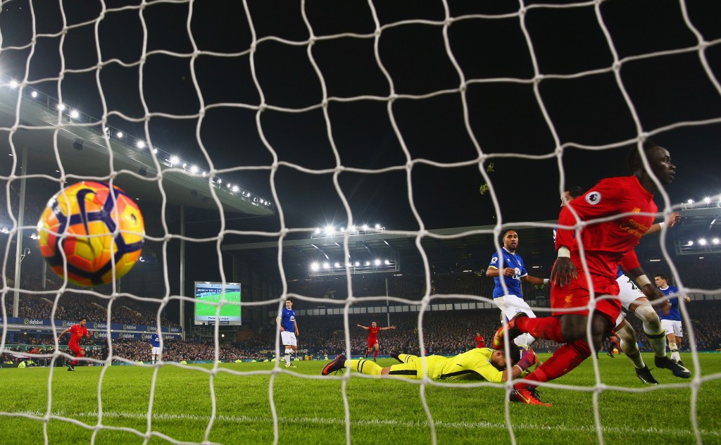 LIVERPOOL, ENGLAND - DECEMBER 19: Sadio Mane of Liverpool (R) celebrates as he scores their first goal during the Premier League match between Everton and Liverpool at Goodison Park on December 19, 2016 in Liverpool, England. (Photo by Clive Brunskill/Getty Images)