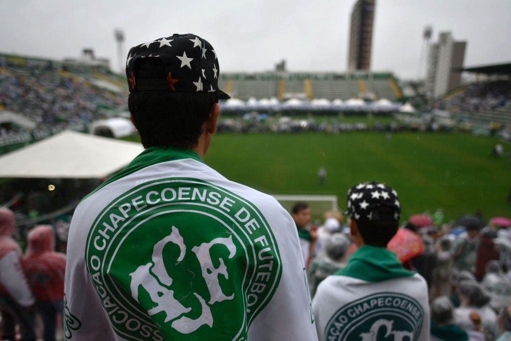 People await for the arrival of the funeral cortege of the players of Brazilian football team Chapecoense Real killed in a plane crash in the Colombian mountains, at the Arena Conda stadium in Chapeco, in the southern Brazilian state of Santa Catarina, on December 3, 2016. The first of two Brazilian air force planes carrying the remains of a football team killed in a plane crash arrived Saturday in the city of Chapeco in southern Brazil. / AFP / DOUGLAS MAGNO (Photo credit should read DOUGLAS MAGNO/AFP/Getty Images)