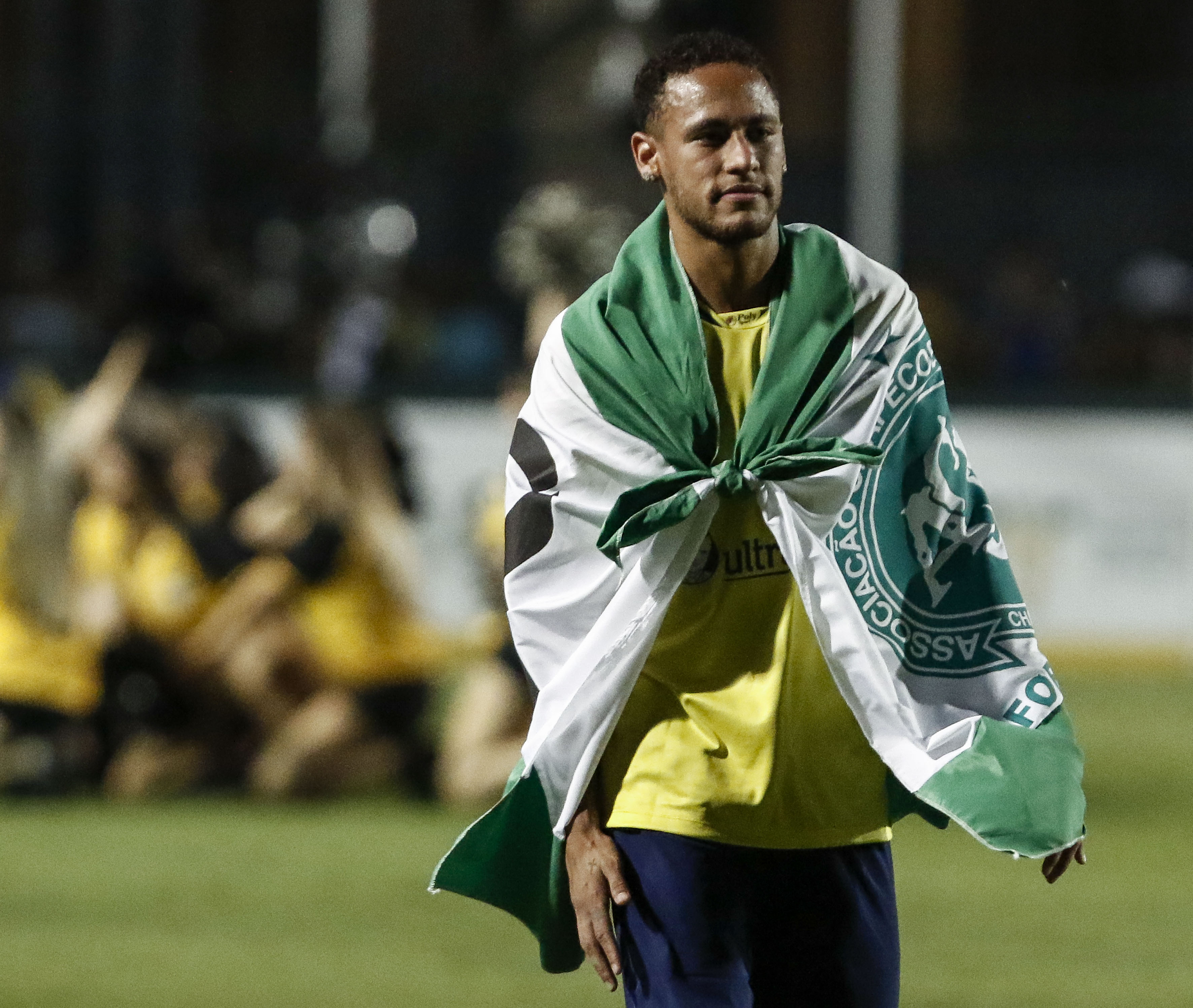 Brazil's Neymar of Spanish team Barcelona uses a flag in tribute to the victims of the November 28, 2016 Colombia plane crash that killed nearly the entire Brazilian Chapecoense football team during the charity football match Ousadia vs Pedalada at Pacaembu stadium in Sao Paulo, on December 22, 2016.
Donations will go to the Neymar Jr. Project Institute in Praia Grande, São Paulo. / AFP / Miguel SCHINCARIOL (Photo credit should read MIGUEL SCHINCARIOL/AFP/Getty Images)