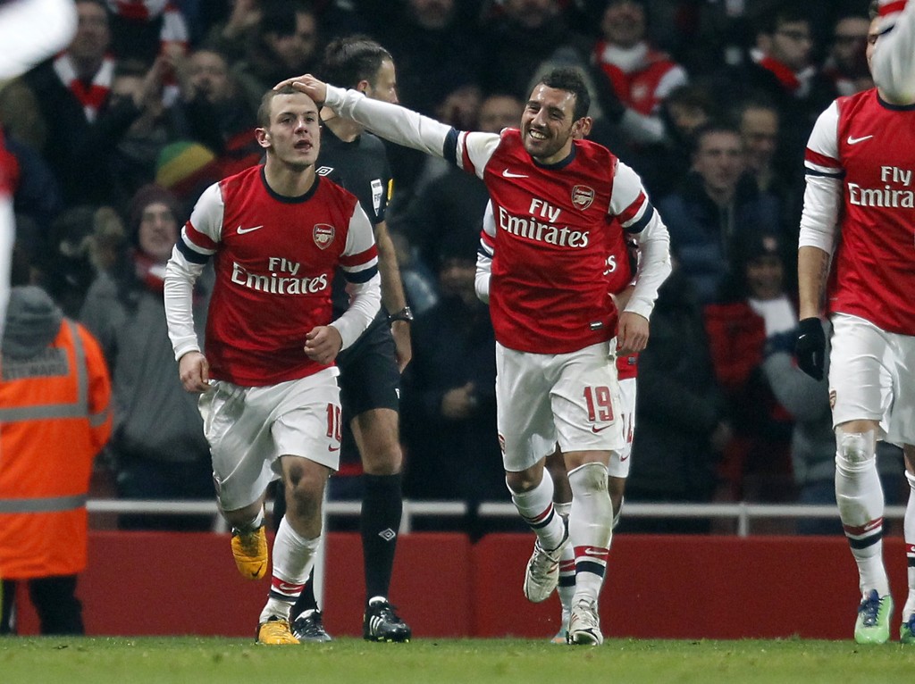 Arsenal's English midfielder Jack Wilshere (L) celebrates scoring their goal with Arsenal's Spanish midfielder Santi Cazorla (R) during the English FA Cup third round replay football match between Arsenal and Swansea City at the Emirates Stadium in London on January 16, 2013. Arsenal won the game 1-0. (Photo by Ian Kington/AFP/Getty Images)
