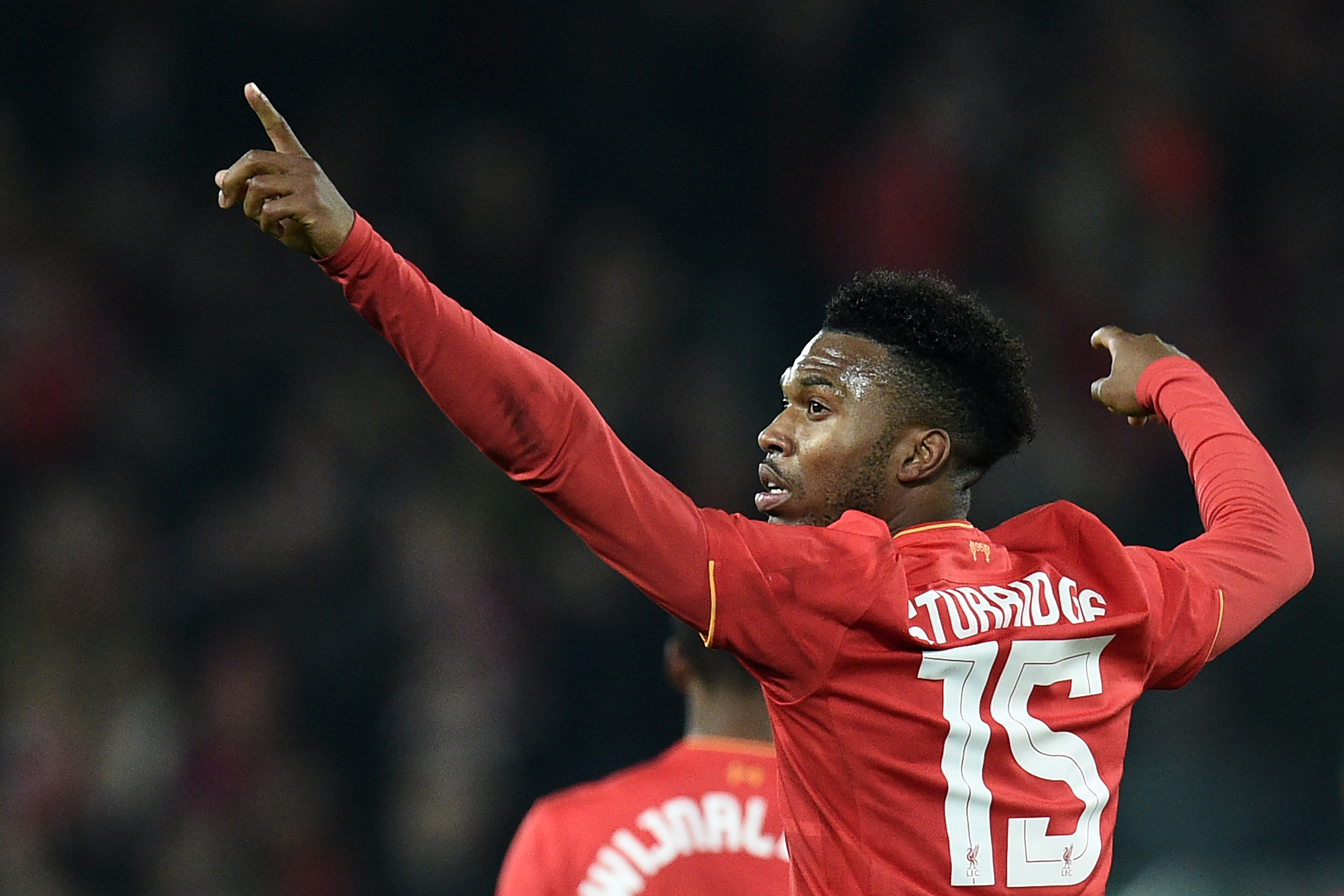 Liverpool's English striker Daniel Sturridge celebrates after scoring their second goal during the EFL (English Football League) Cup fourth round match between Liverpool and Tottenham Hotspur at Anfield in Liverpool north west England on October 25, 2016. / AFP / Oli SCARFF / RESTRICTED TO EDITORIAL USE. No use with unauthorized audio, video, data, fixture lists, club/league logos or 'live' services. Online in-match use limited to 75 images, no video emulation. No use in betting, games or single club/league/player publications. / (Photo credit should read OLI SCARFF/AFP/Getty Images)