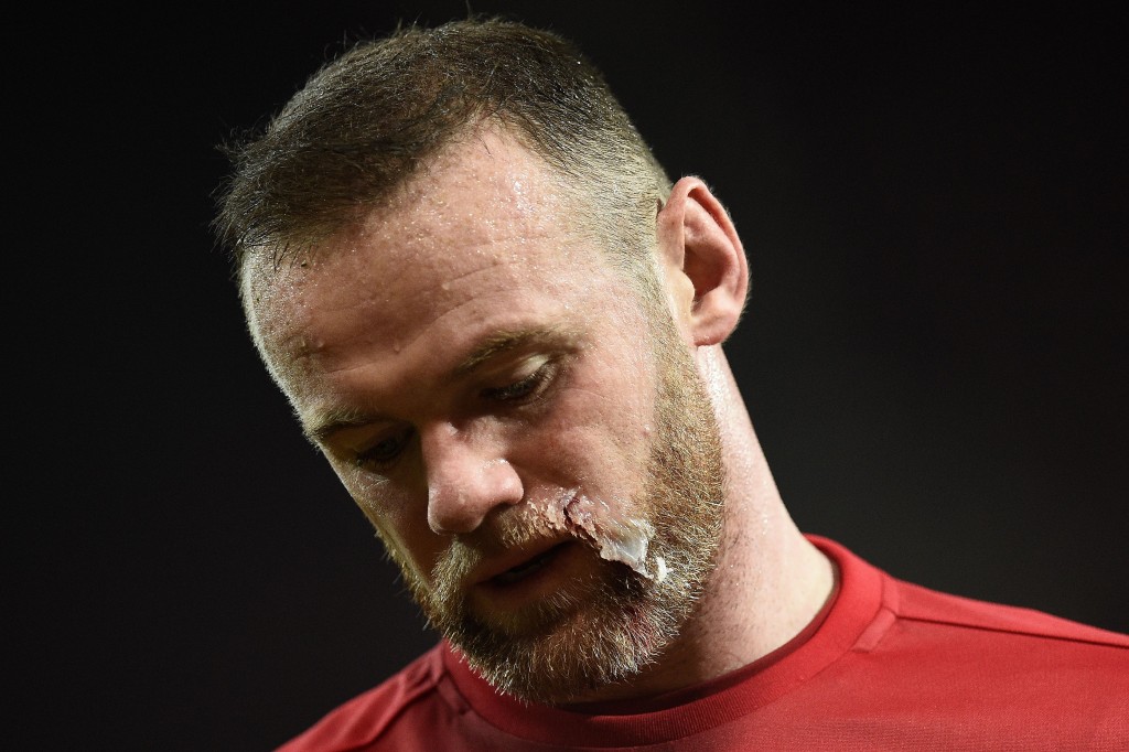 Manchester United's English striker Wayne Rooney returns to the pitch after having treatment to his face during the EFL (English Football League) Cup quarter-final football match between Manchester United and West Ham United at Old Trafford in Manchester, north west England, on November 30, 2016. (Photo by Oli Scarff/AFP/Getty Images)