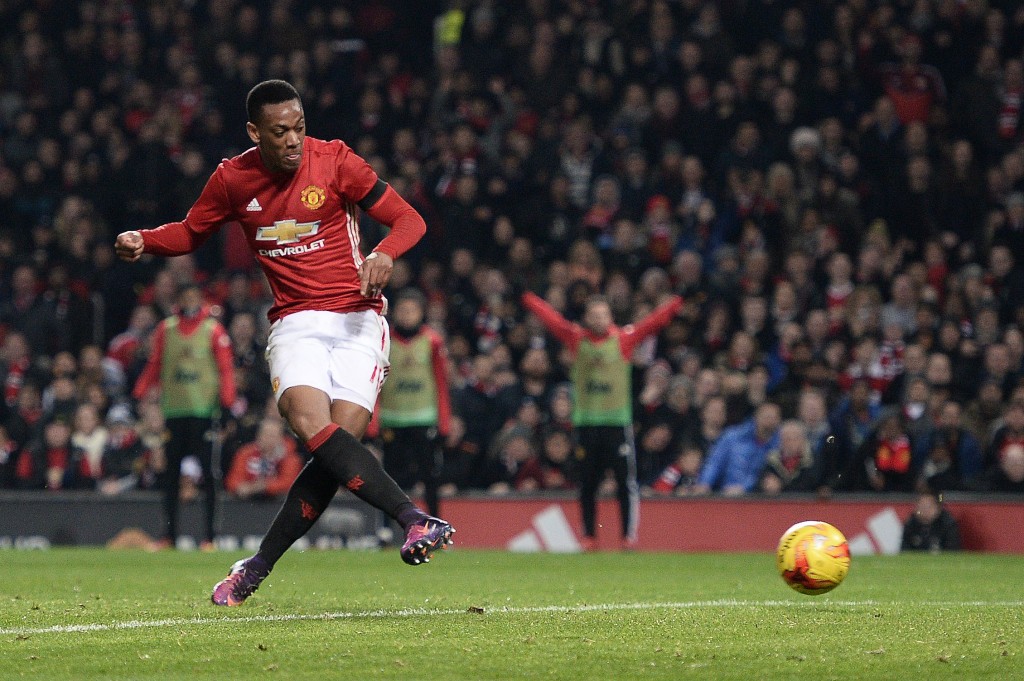 Manchester United's French striker Anthony Martial scores his team's third goal during the EFL (English Football League) Cup quarter-final football match between Manchester United and West Ham United at Old Trafford in Manchester, north west England, on November 30, 2016 (Photo by OLI SCARFF/AFP/Getty Images)
