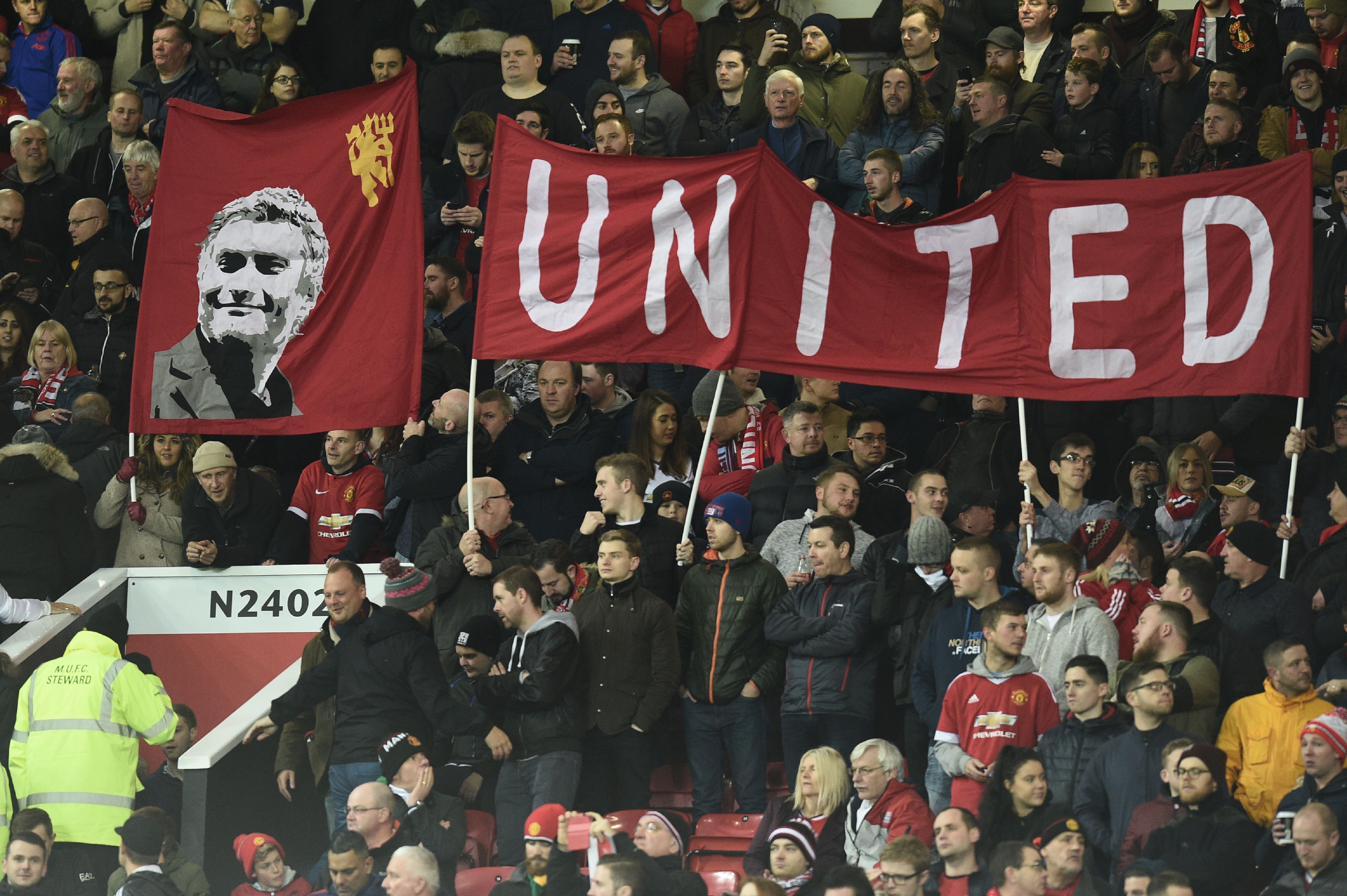 Manchester United banners are seen in the crowd during the English Premier League football match between Manchester United and West Ham United at Old Trafford in Manchester, north west England, on November 27, 2016. / AFP / Oli SCARFF / RESTRICTED TO EDITORIAL USE. No use with unauthorized audio, video, data, fixture lists, club/league logos or 'live' services. Online in-match use limited to 75 images, no video emulation. No use in betting, games or single club/league/player publications. / (Photo credit should read OLI SCARFF/AFP/Getty Images)