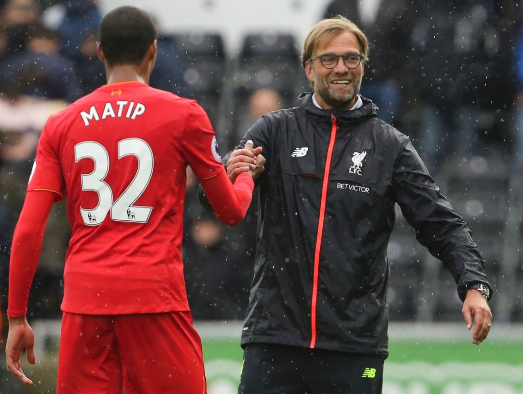 Liverpool's German manager Jurgen Klopp (R) shakes hands with Liverpool's German-born Cameroonian defender Joel Matip (L) at the end of the English Premier League football match between Swansea City and Liverpool at The Liberty Stadium in Swansea, south Wales on October 1, 2016.(Photo by Geoff Caddick/AFP/Getty Images)