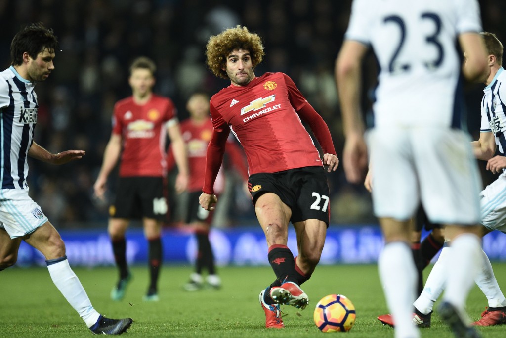 Manchester United's Belgian midfielder Marouane Fellaini passes the ball during the English Premier League football match between West Bromwich Albion and Manchester United at The Hawthorns stadium in West Bromwich, central England, on December 17, 2016. (Photo by Oli Scarff/AFP/Getty Images)