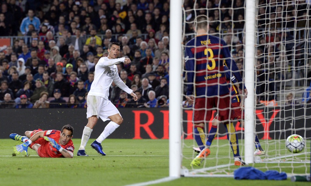 Real Madrid's Portuguese forward Cristiano Ronaldo (L) looks at the ball after scoring a goal during the Spanish league "Clasico" football match FC Barcelona vs Real Madrid CF at the Camp Nou stadium in Barcelona on April 2, 2016. (Photo by JOSEP LAGO/AFP/Getty Images)