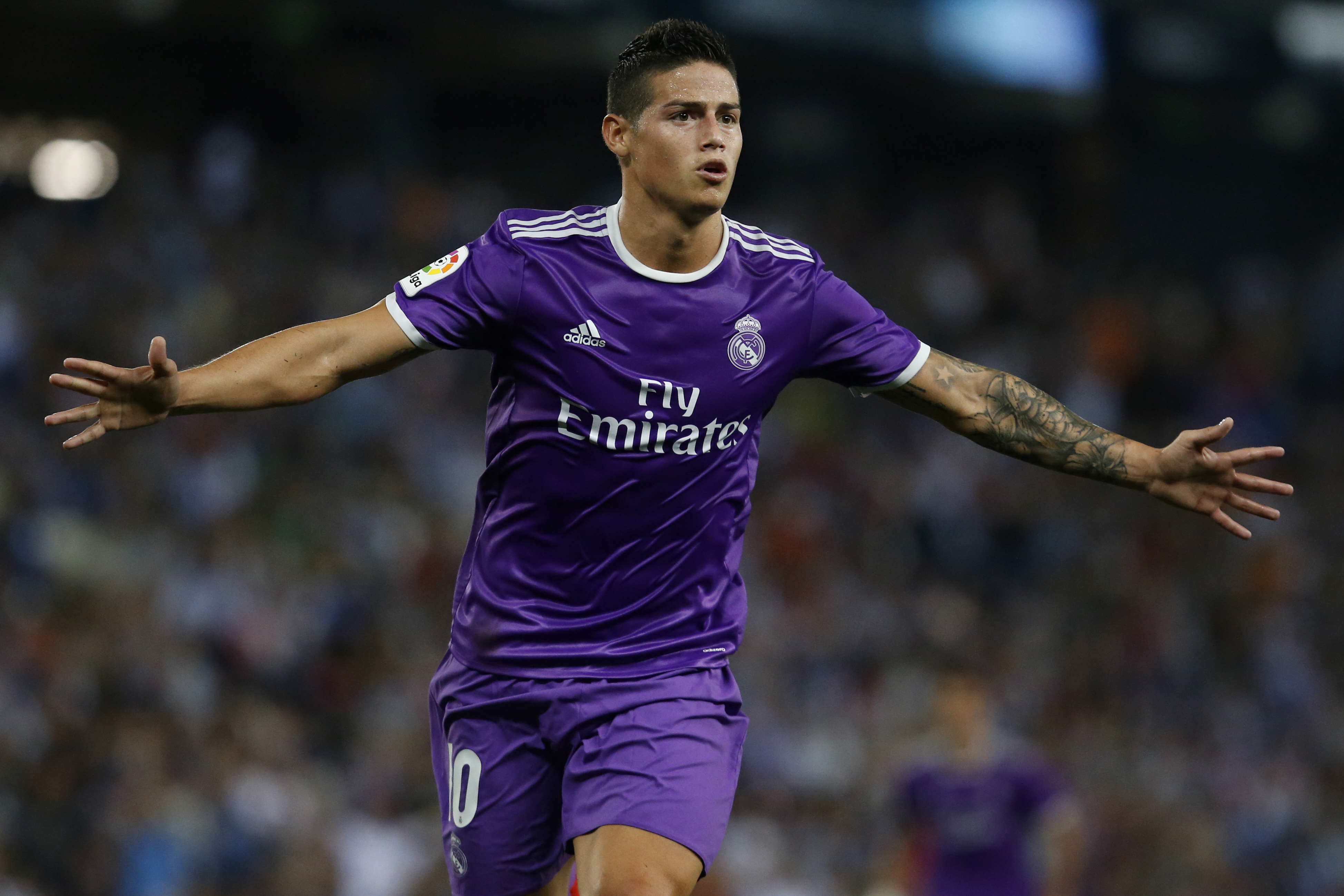 Real Madrid's Colombian midfielder James Rodriguez celebrates after scoring during the Spanish league football match RCD Espanyol vs Real Madrid CF at the Cornella-El Prat stadium in Cornella de Llobregat on September 18, 2016. / AFP / PAU BARRENA (Photo credit should read PAU BARRENA/AFP/Getty Images)