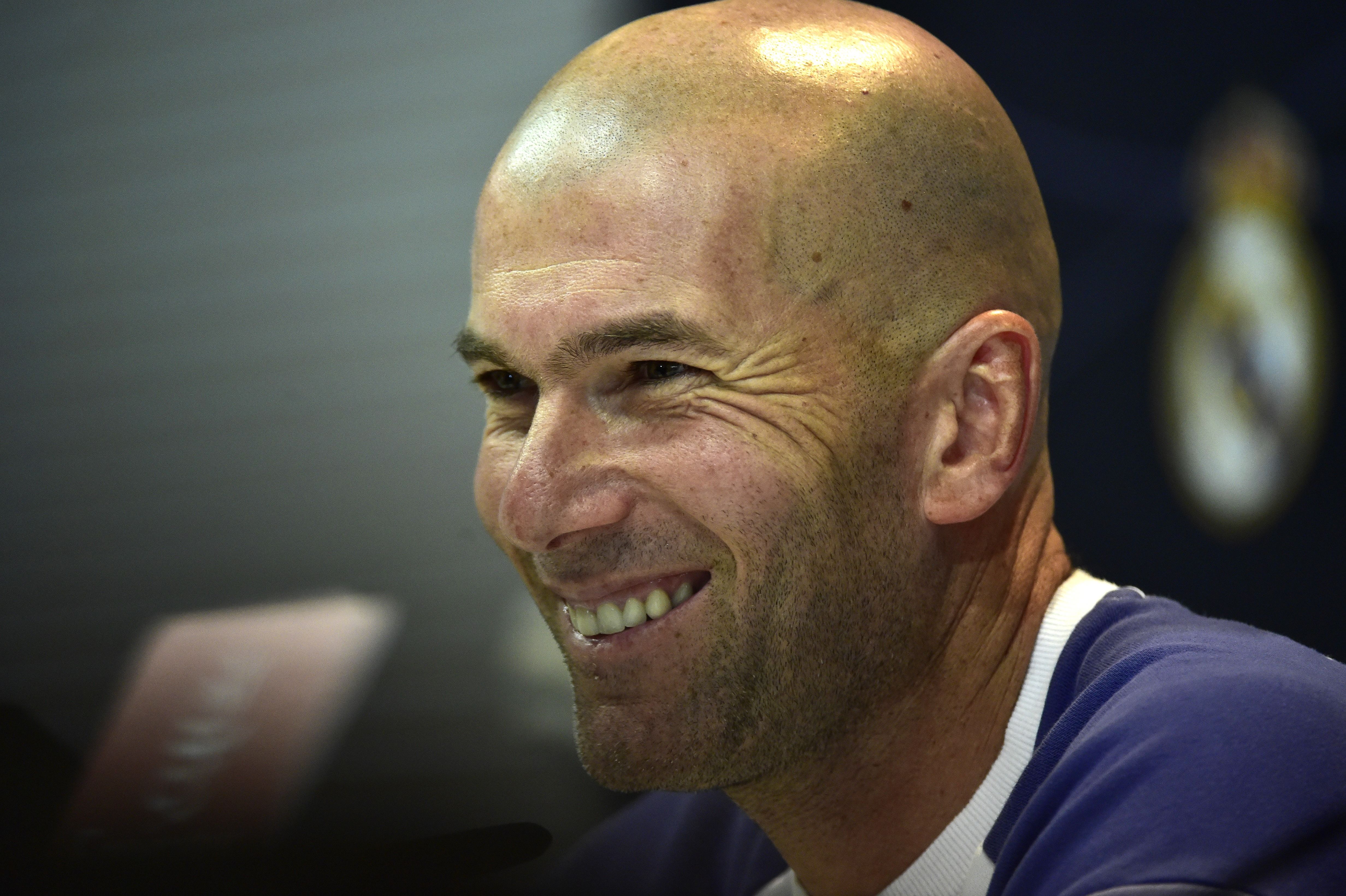 Real Madrid's French coach Zinedine Zidane smiles during a press conference at Valdebebas Sport City in Madrid on December 9, 2016 on the eve of the Spanish League match Real Madrid CF vs RC Deportivo de La Coruna. / AFP / GERARD JULIEN (Photo credit should read GERARD JULIEN/AFP/Getty Images)