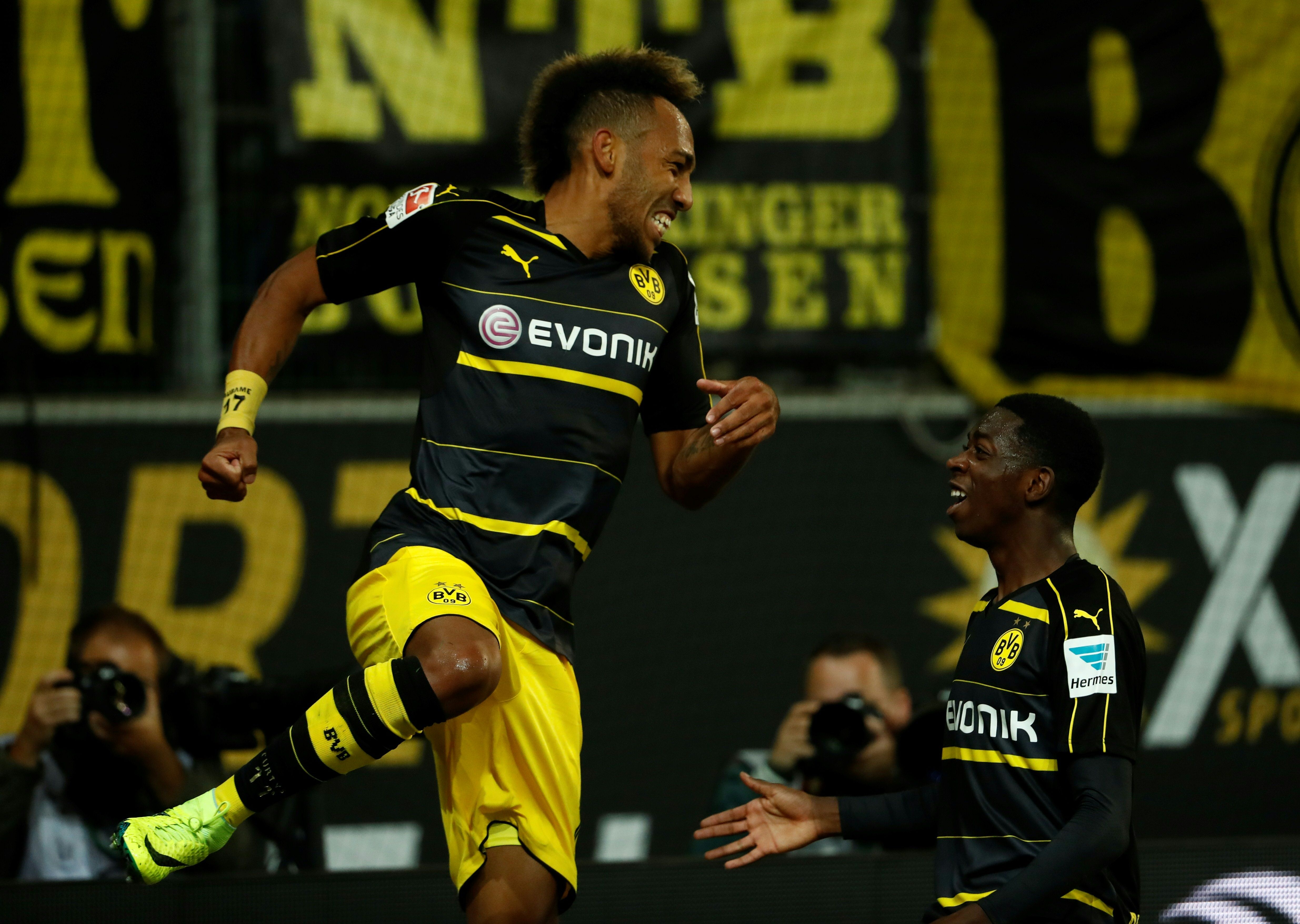 Dortmund's Gabonese forward Pierre-Emerick Aubameyang (L) and Dortmund's French midfielder Ousmane Dembele celebrate during the German first division Bundesliga football match between VfL Wolfsburg and Borussia Dortmund at Volkswagen Arena in Wolfsburg, central Germany, on September 20, 2016. / AFP / Odd ANDERSEN / RESTRICTIONS: DURING MATCH TIME: DFL RULES TO LIMIT THE ONLINE USAGE TO 15 PICTURES PER MATCH AND FORBID IMAGE SEQUENCES TO SIMULATE VIDEO. == RESTRICTED TO EDITORIAL USE == FOR FURTHER QUERIES PLEASE CONTACT DFL DIRECTLY AT + 49 69 650050
(Photo credit should read ODD ANDERSEN/AFP/Getty Images)