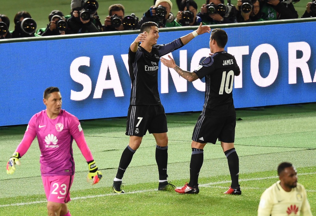 Real Madrid's forward Cristiano Ronaldo (2nd L) is congratulated by teammate James Rodriguez (#10) after scoring a goal during the Club World Cup semi-final football match between Mexico's Club America and Spain's Real Madrid at Yokohama International stadium in Yokohama on December 15, 2016. / AFP / TORU YAMANAKA (Photo credit should read TORU YAMANAKA/AFP/Getty Images)