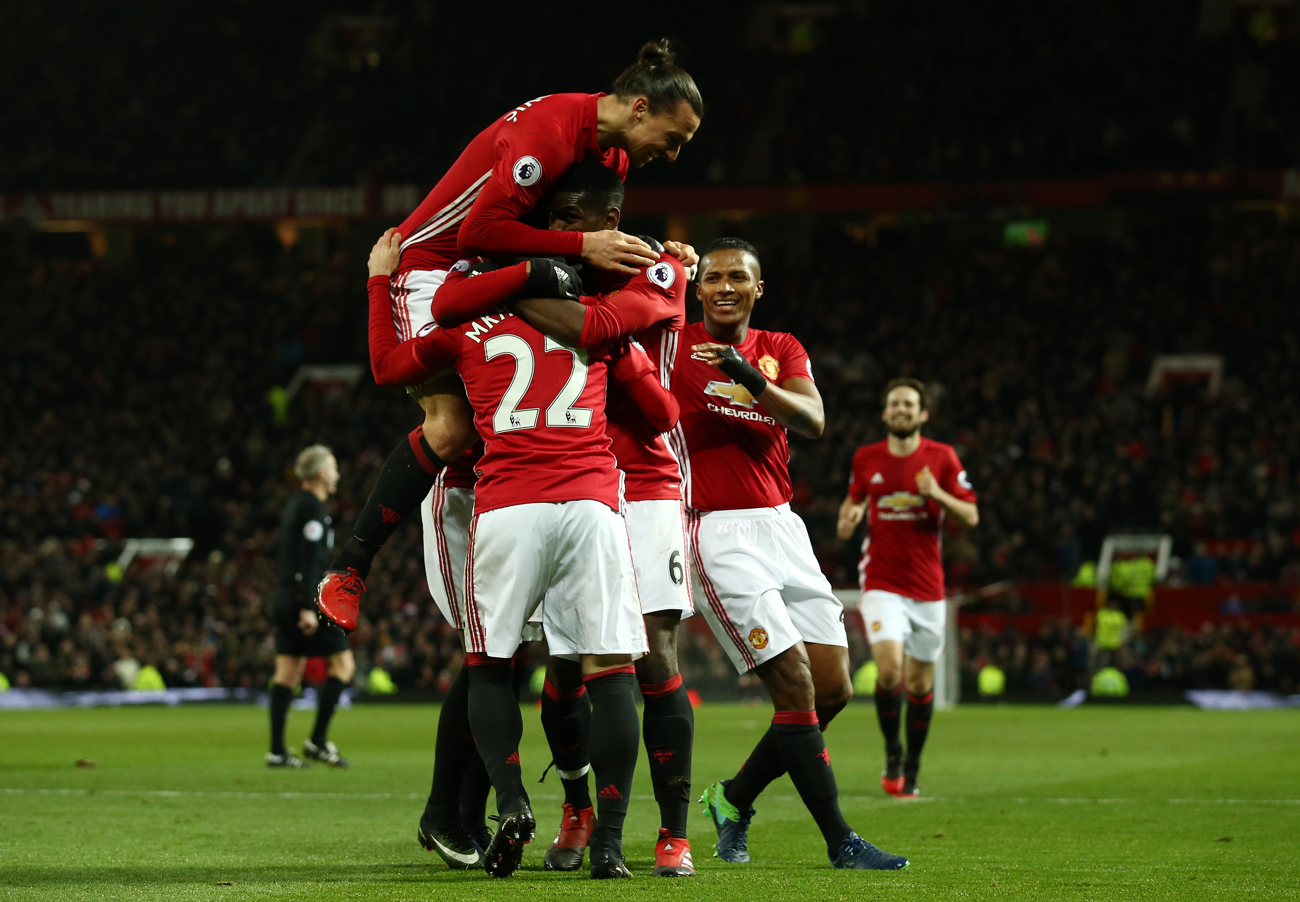 MANCHESTER, ENGLAND - DECEMBER 26: Henrikh Mkhitaryan #22 of Manchester United celebrates with teammates after scoring his team's third goal during the Premier League match between Manchester United and Sunderland at Old Trafford on December 26, 2016 in Manchester, England. (Photo by Jan Kruger/Getty Images)