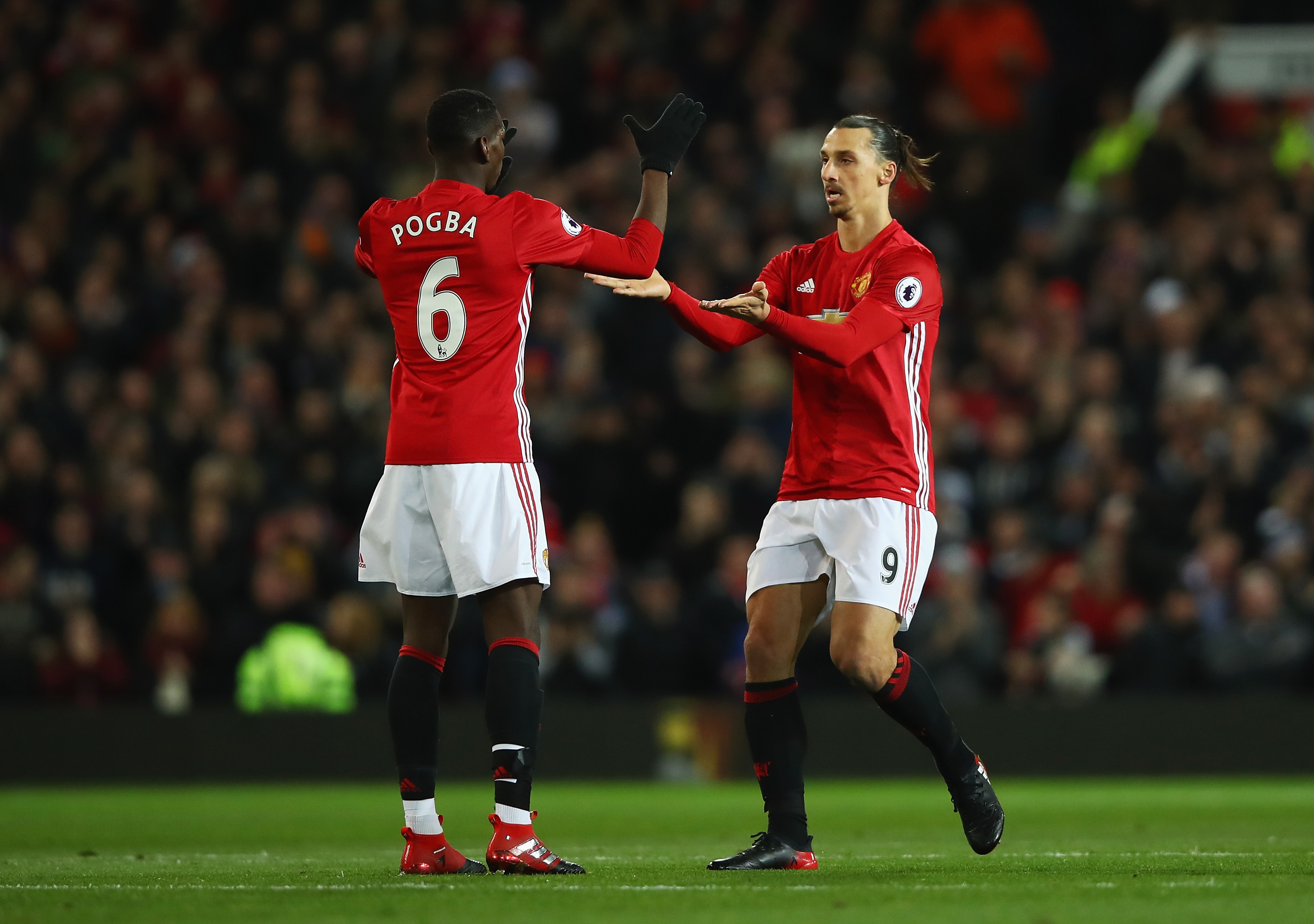 MANCHESTER, ENGLAND - NOVEMBER 27: Zlatan Ibrahimovic of Manchester United (R) celebrates scoring his sides first goal with Paul Pogba of Manchester United (L) during the Premier League match between Manchester United and West Ham United at Old Trafford on November 27, 2016 in Manchester, England. (Photo by Clive Brunskill/Getty Images)