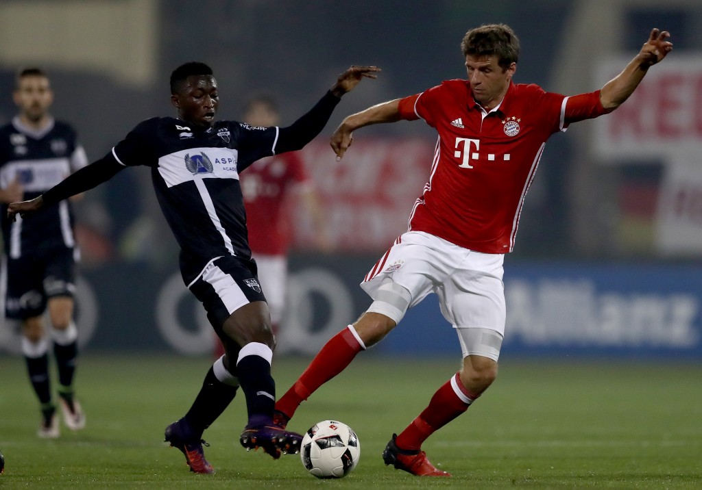 DOHA, QATAR - JANUARY 10: Amani Lazare of Eupen challenges Thomas Mueller of Muenchen during the friendly match between Bayern Muenchen and KAS Eupen on January 10, 2017 in Doha, Qatar. (Photo by Lars Baron/Bongarts/Getty Images)