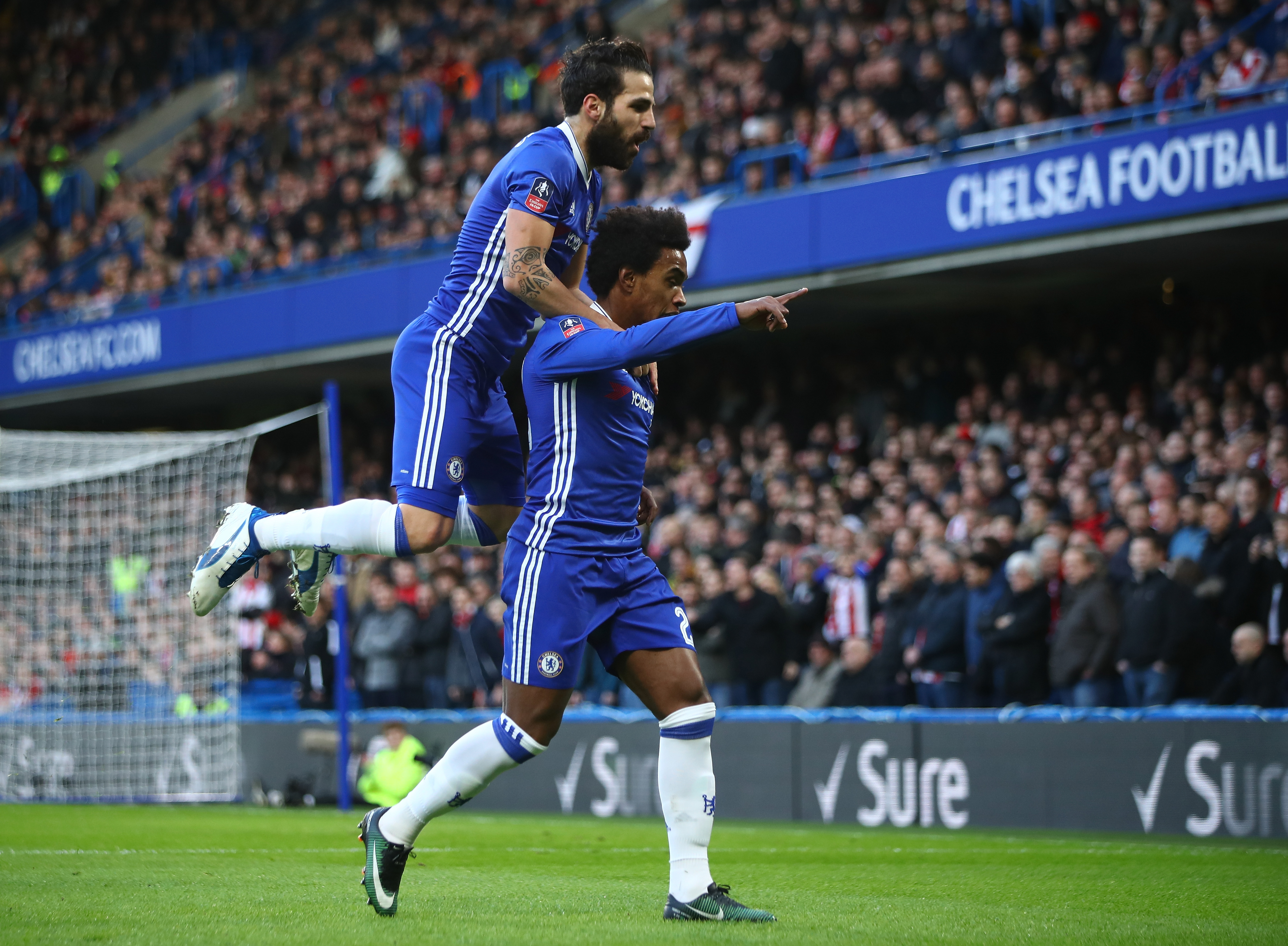 LONDON, ENGLAND - JANUARY 28: Willian (R) of Chelsea celebrates scoring the opening goal with his team mate Cesc Fabregas (L) during the Emirates FA Cup Fourth Round match between Chelsea and Brentford at Stamford Bridge on January 28, 2017 in London, England. (Photo by Clive Mason/Getty Images)